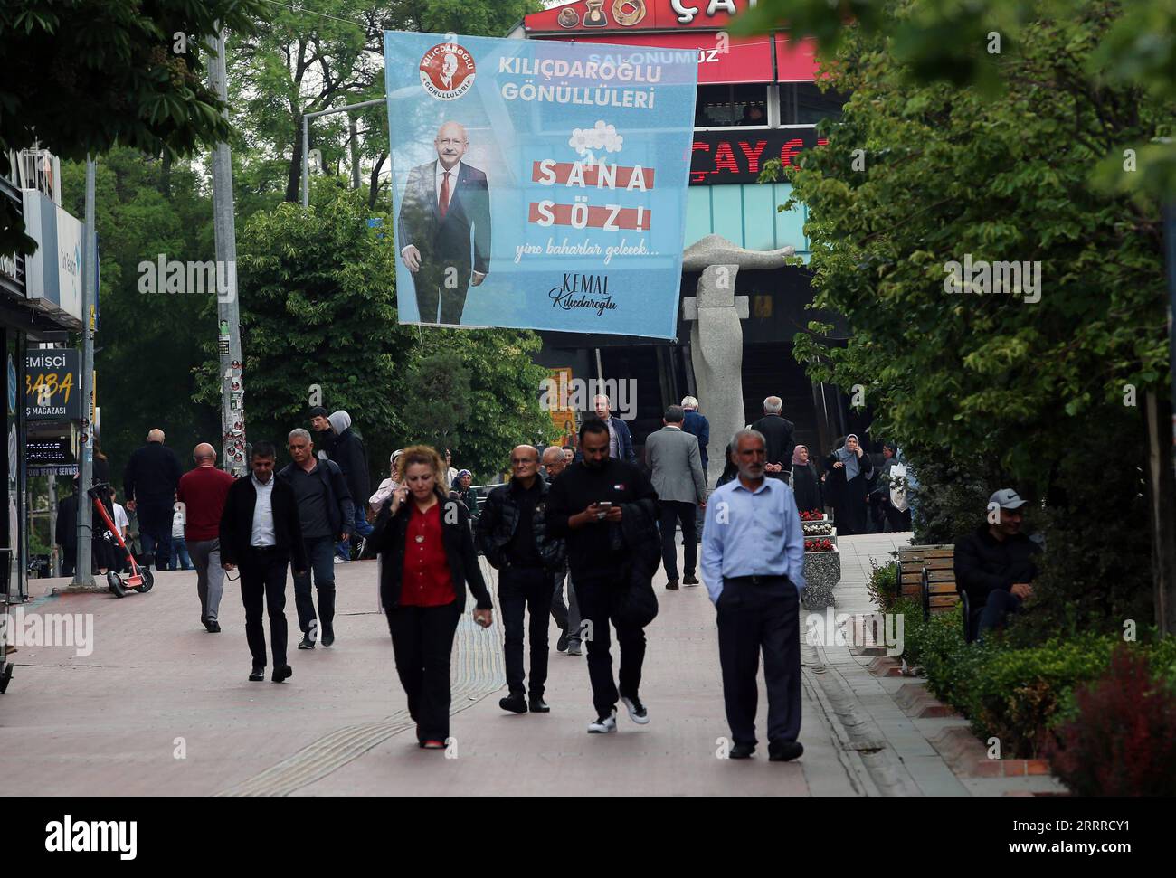 230523 -- ANKARA, May 23, 2023 -- People walk by an election