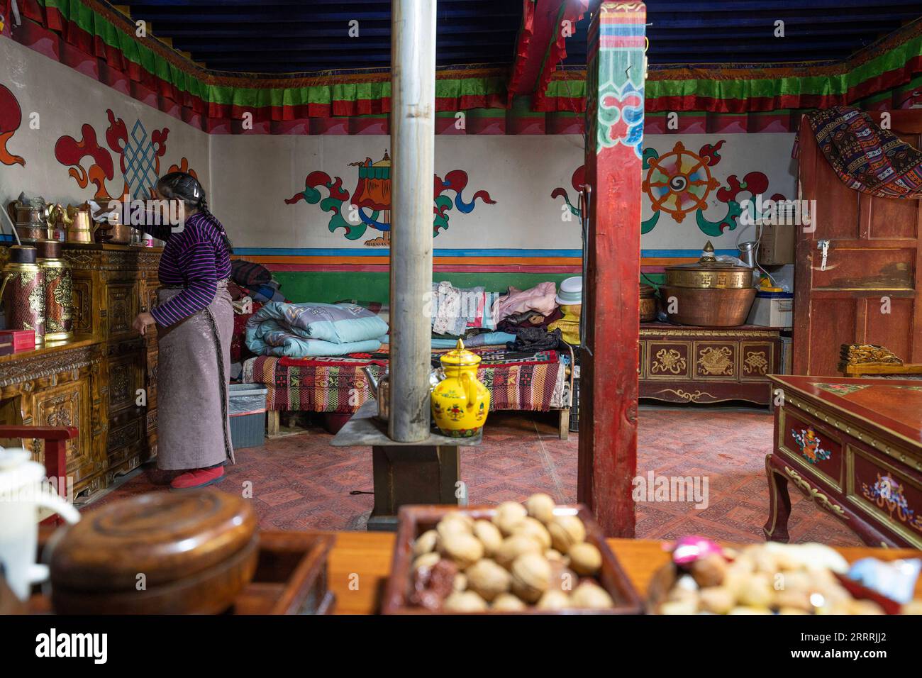 230531 -- NGARI, May 31, 2023 -- A relative in-law of Losang Zhamdu cleans the living room of her third-generation house in Demqog Village, Zhaxigang Township, Gar County in Ngari Prefecture of southwest China s Tibet Autonomous Region, May 28, 2023. Sitting in the sun outside his residence in Demqog Village, Zhaxigang Township, Gar County in Ngari Prefecture of Tibet, 84-year-old Losang Zhamdu told a story of the five homes he had lived in. My mother and I lived together in a tent made with yak hair, all our possessions were a goat fur jacket and a worn-out Tibetan blanket, recalled Losang Zh Stock Photo