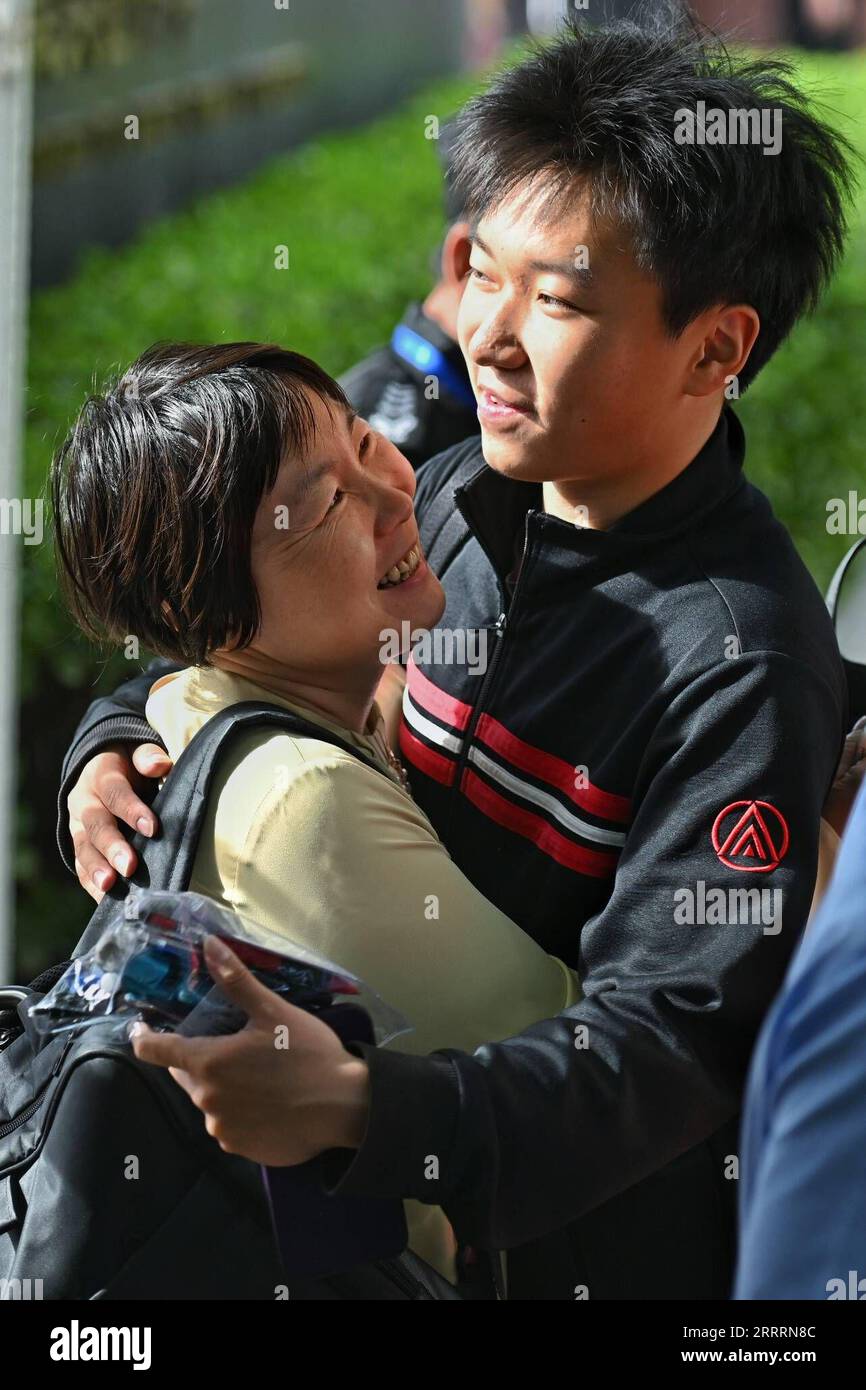 230607 -- BEIJING, June 7, 2023 -- A mother hugs her son outside