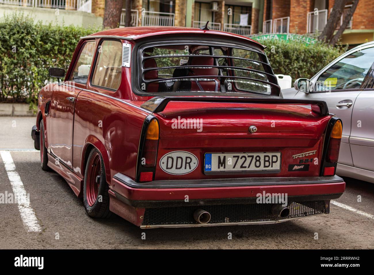 Red Trabant 601 on the parking lot in the city Stock Photo