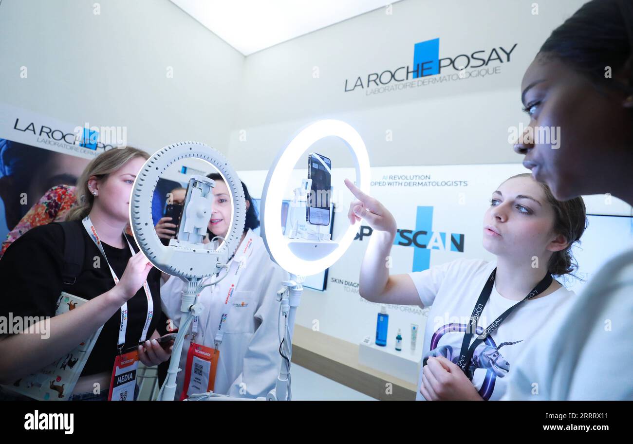 230616 -- PARIS, June 16, 2023 -- Visitors try La Roche-Posay SPOTSCAN, a  diagnostic and coaching tool, at the l Oreal pavillon at the VivaTech  technology start-ups and innovation fair in Paris,