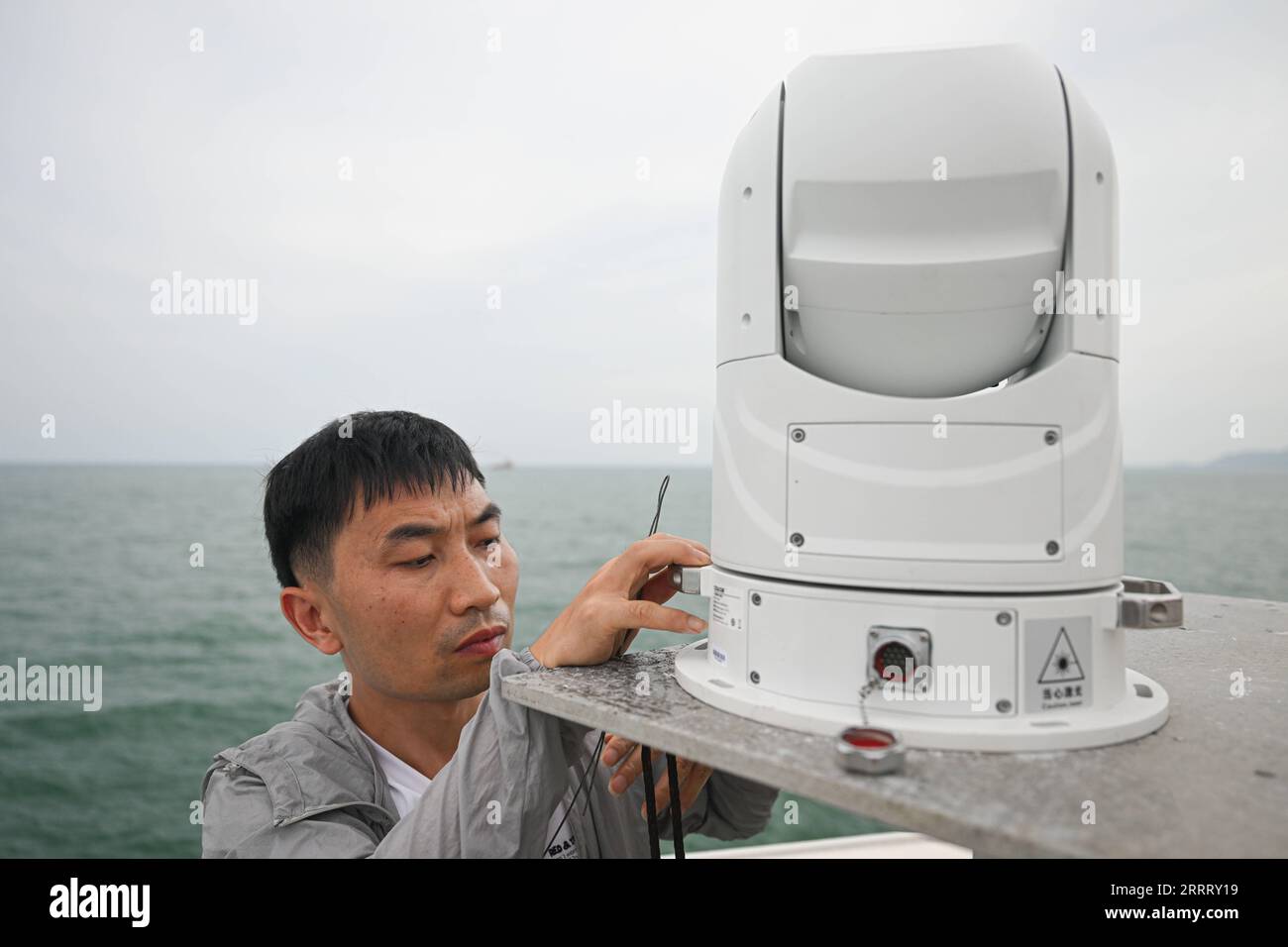 230617 -- HAIKOU, June 17, 2023 -- A staff member installs a high-definition optoelectronic device before conducting an open-sea testing of the low-Earth orbit broadband communication test constellation at the Dian Ke No.1 comprehensive test ship, June 14, 2023. Researchers from the GalaxySpace, a Beijing-based satellite maker, and several scientific research institutions, conducted an open-sea testing of the country s first low-Earth orbit broadband communication test constellation in the South China Sea. The testing aims to verify the collaborative communication coverage ability of high-Eart Stock Photo