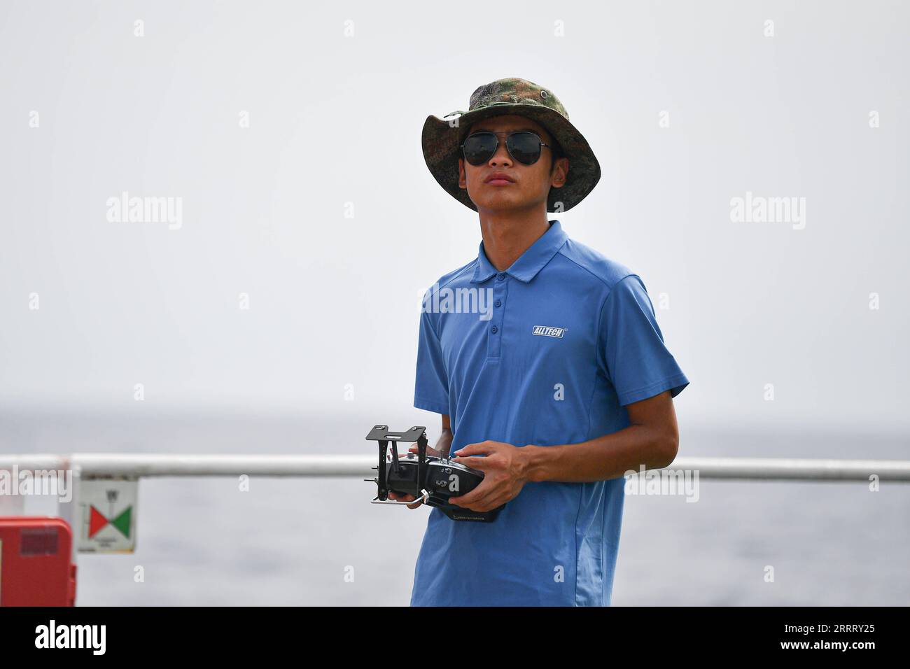 230617 -- HAIKOU, June 17, 2023 -- A staff member operates an unmanned aerial vehicle to conduct an open-sea testing of the low-Earth orbit broadband communication test constellation at the Dian Ke No.1 comprehensive test ship, June 15, 2023. Researchers from the GalaxySpace, a Beijing-based satellite maker, and several scientific research institutions, conducted an open-sea testing of the country s first low-Earth orbit broadband communication test constellation in the South China Sea. The testing aims to verify the collaborative communication coverage ability of high-Earth orbit and low-Eart Stock Photo