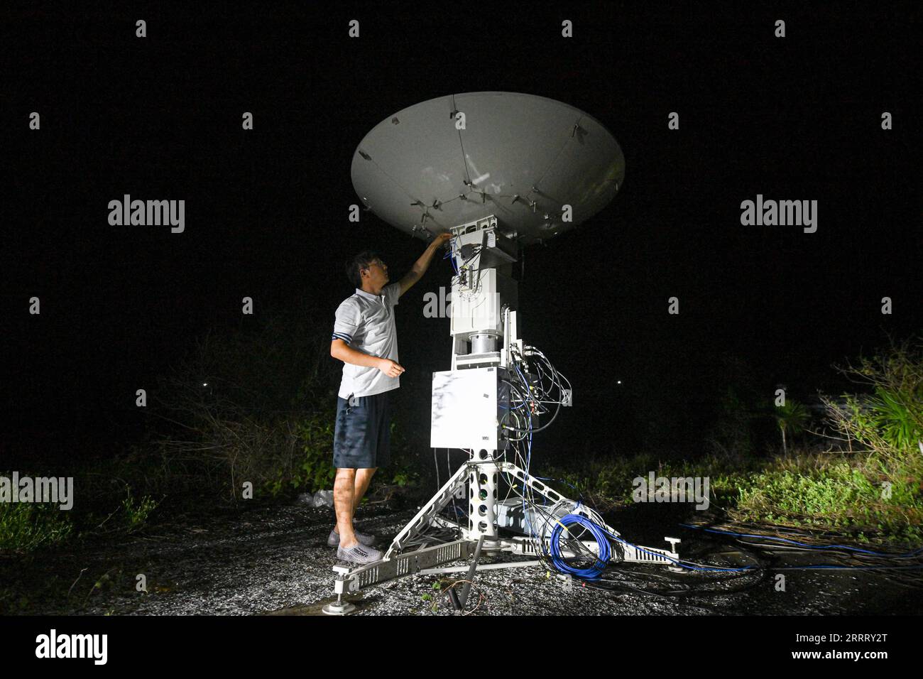 230617 -- HAIKOU, June 17, 2023 -- A staff member tests a signal reception device for low-Earth orbit satellites at a low-Earth orbit gateway station in Lingshui Li Autonomous County, south China s Hainan Province, June 13, 2023. Researchers from the GalaxySpace, a Beijing-based satellite maker, and several scientific research institutions, conducted an open-sea testing of the country s first low-Earth orbit broadband communication test constellation in the South China Sea. The testing aims to verify the collaborative communication coverage ability of high-Earth orbit and low-Earth orbit satel Stock Photo