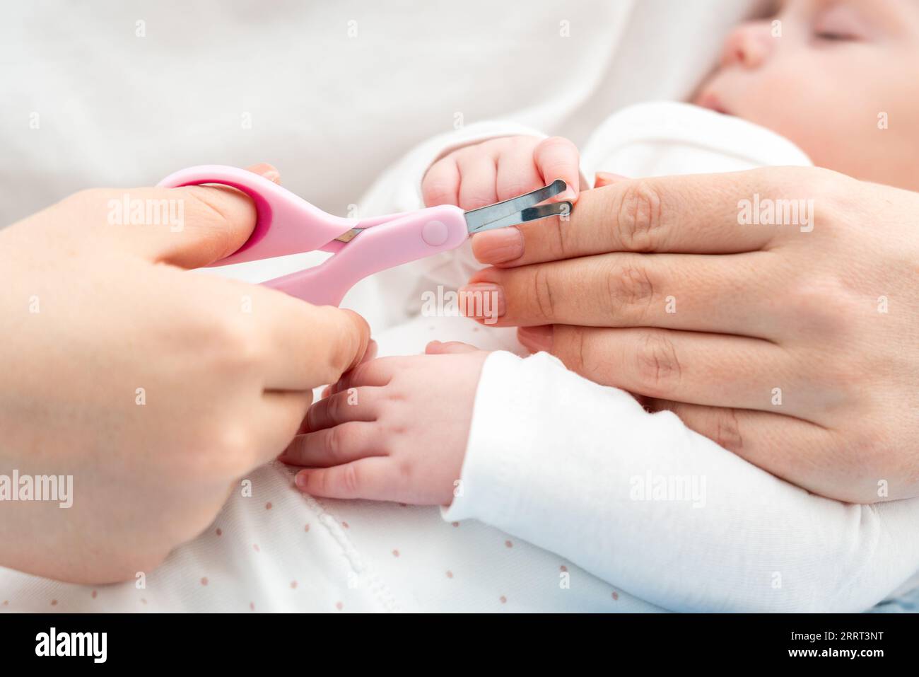 A man cuts her nails child hygiene. men's hands hold nail scissors Stock  Photo by Vailery