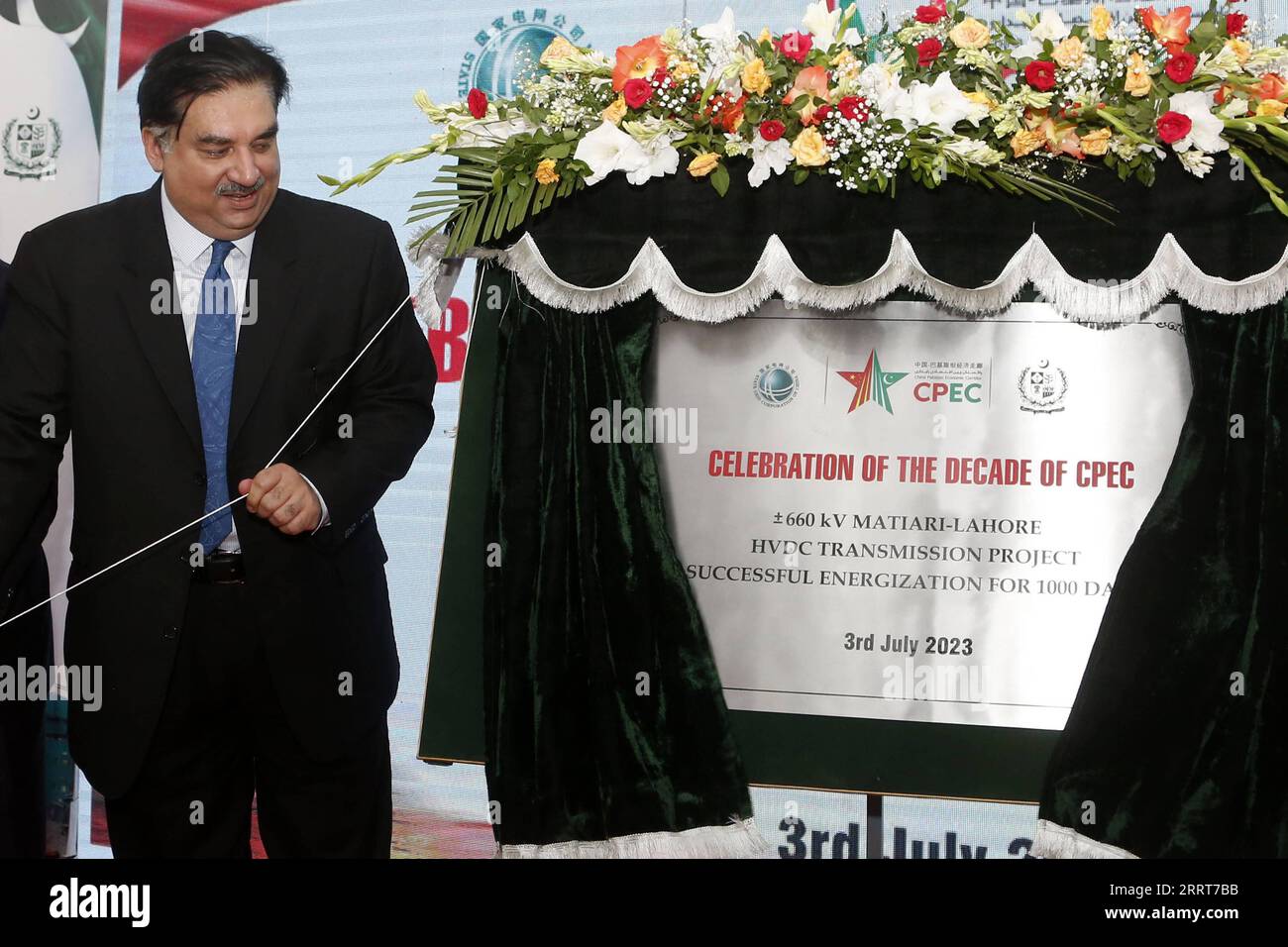 230704 -- LAHORE, July 4, 2023 -- Pakistan s Minister for Power Khurram Dastgir Khan unveils a plaque during the celebrations of safe operation for 1,000-days of the À660kV Matiari-Lahore high-voltage direct current HVDC transmission project under the China-Pakistan Economic Corridor CPEC on the outskirts of Lahore, Pakistan on July 3, 2023. Pakistan s Minister for Power Khurram Dastgir Khan said Monday that with the inception of the China-Pakistan Economic Corridor CPEC 10 years ago, the relations between the two countries qualitatively changed into a deep economic partnership. TO GO WITH CPE Stock Photo