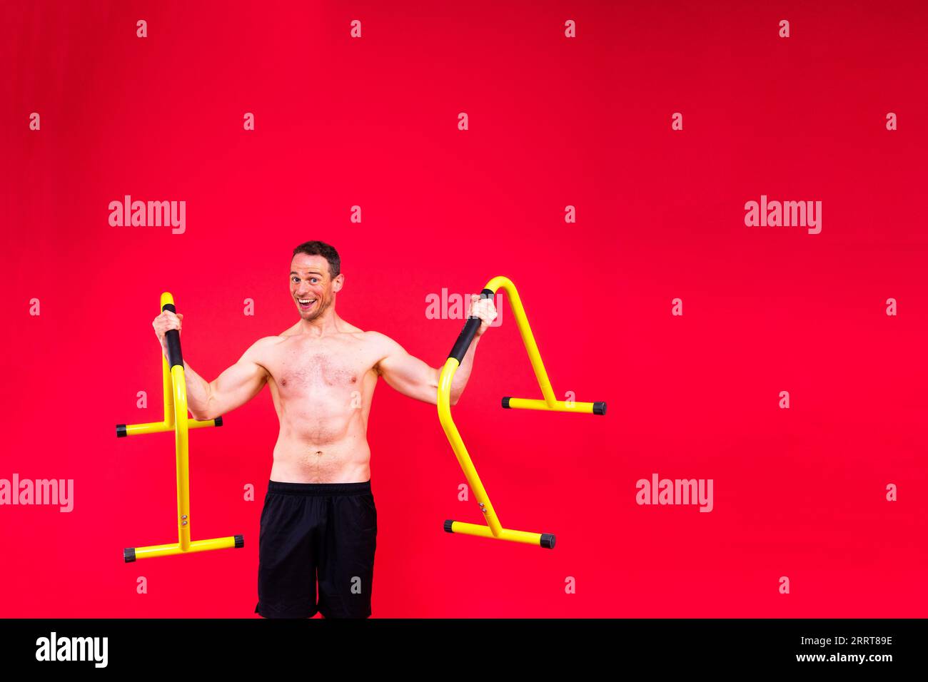 Strong man doing sports. Fitness on gorizontal and parallel bars. Pull