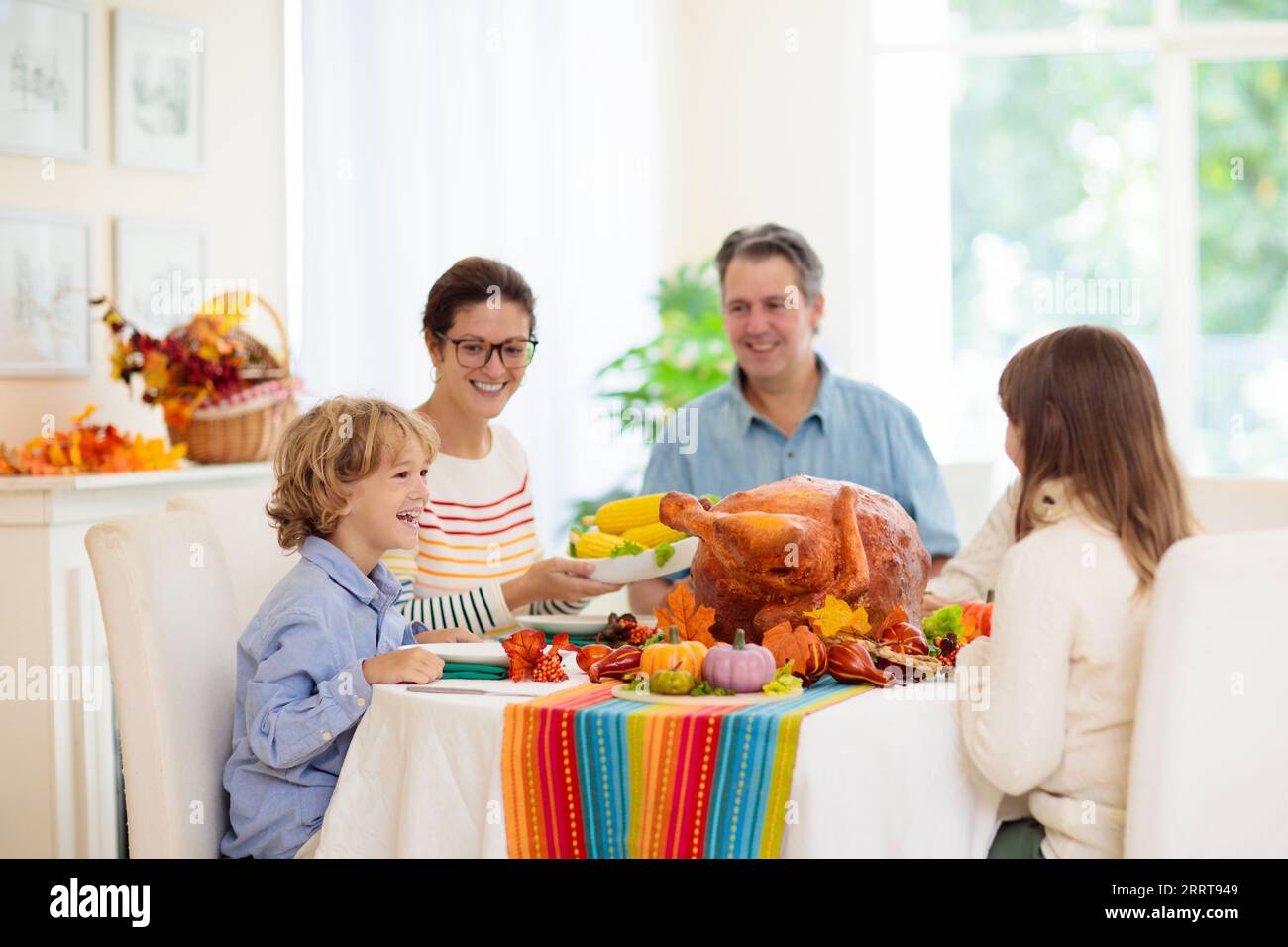 Family at Thanksgiving dinner. Parents and kids enjoy roasted turkey