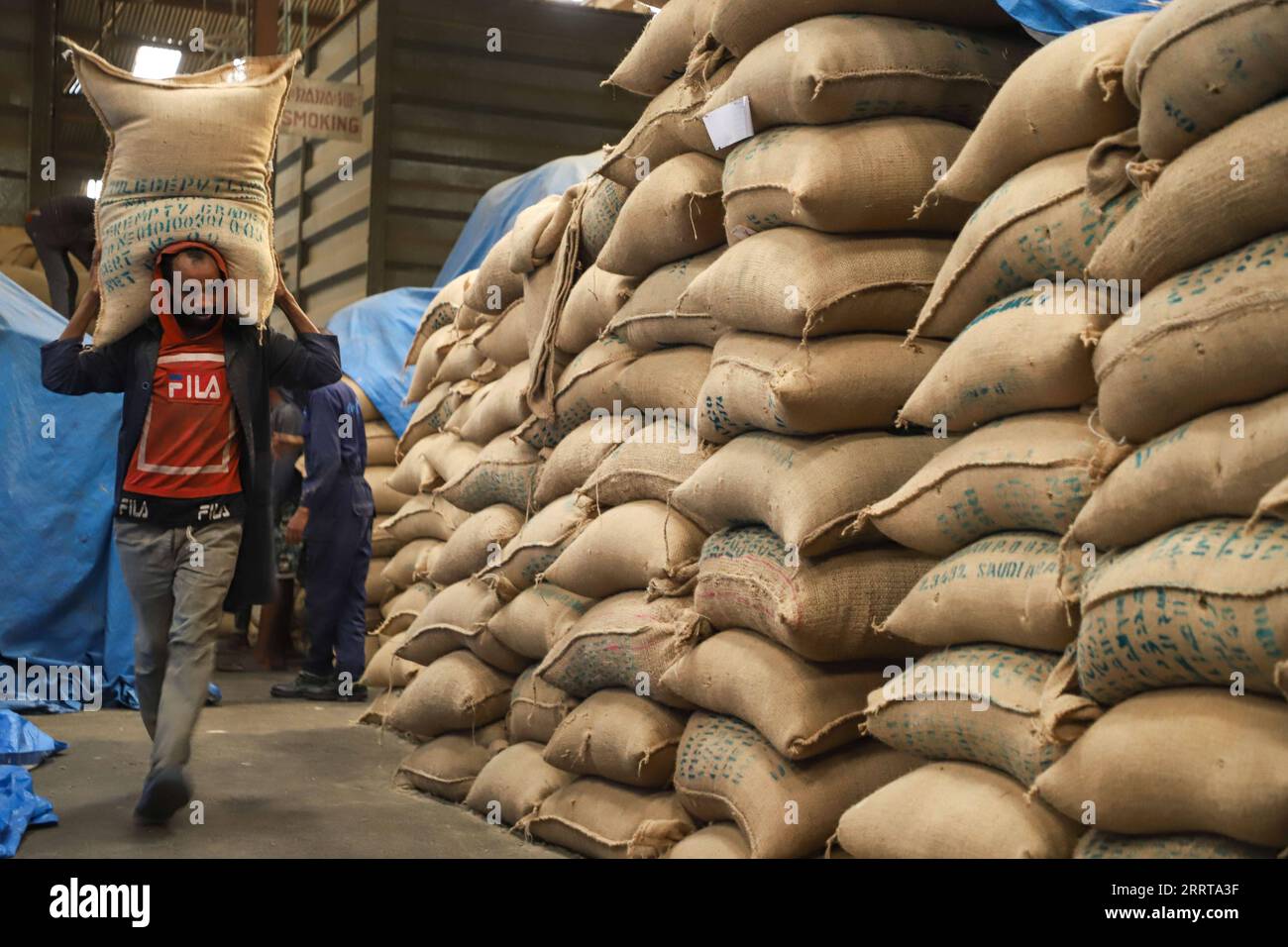 230708 -- ADDIS ABABA, July 8, 2023 -- A worker carries coffee beans in a warehouse at Mullege Coffee Export PLC, one of Ethiopia s leading coffee exporting firms, in Addis Ababa, Ethiopia, July 1, 2023. TO GO WITH Feature: Ethiopian coffee exporters enjoy growing demand in China  ETHIOPIA-ADDIS ABABA-COFFEE-EXPORT-CHINA MichaelxTewelde PUBLICATIONxNOTxINxCHN Stock Photo