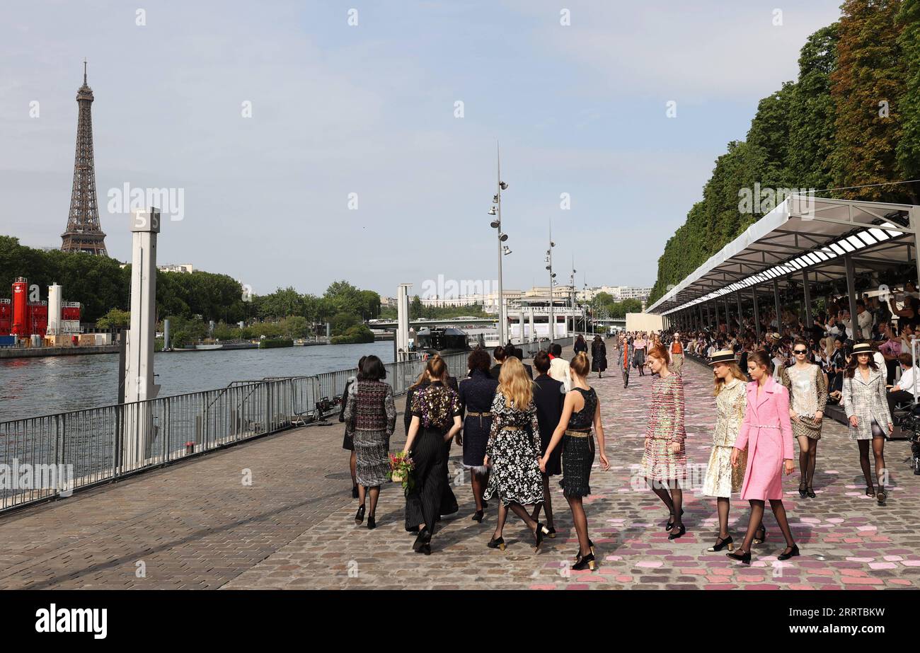 230713 -- PARIS, July 13, 2023 -- A fashion show is held by the Seine ...
