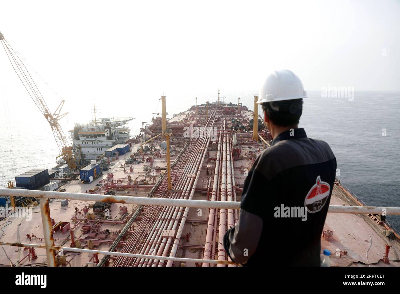 230716 -- HODEIDAH, July 16, 2023 -- A engineer stands on the upper decker of the FSO Safer, a super oil tanker that has been left unattended for years, at Ras Issa Port in Hodeidah Province, Yemen, on July 15, 2023. A vessel chartered by the United Nations set sail from Djibouti on Saturday toward Yemen to transfer oil from a deteriorating tanker that poses a major environmental and humanitarian threat. The replacement vessel, Nautica, is expected to arrive at the site of the FSO Safer supertanker on Sunday. Once it arrives, a meticulous ship-to-ship transfer operation will be initiated to ex Stock Photo