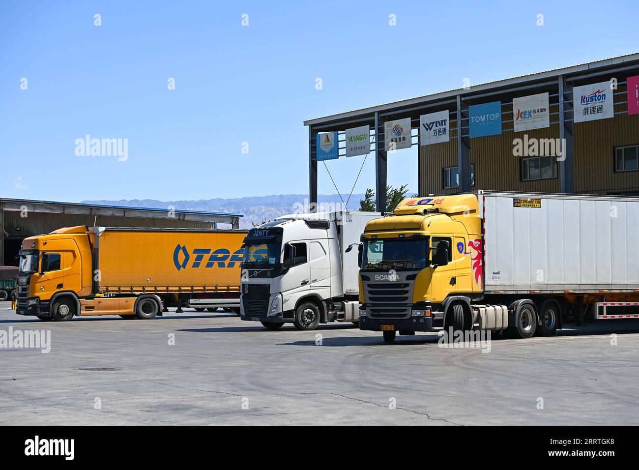 230725 -- ALATAW PASS, July 25, 2023 -- Cargo trucks wait to be loaded at the custom clearance center for the cross-border e-commerce of the Alataw Pass comprehensive bonded area in northwest China s Xinjiang Uygur Autonomous Region, July 24, 2023. In recent years, various measures have been taken to create a better business environment for cross-border e-commerce enterprises in Alataw Pass. The cross-border e-commerce business was launched in the inland port in northwest China s Xinjiang Uygur Autonomous Region in January 2020. In the first half of this year, more than 14.50 million cross-bor Stock Photo