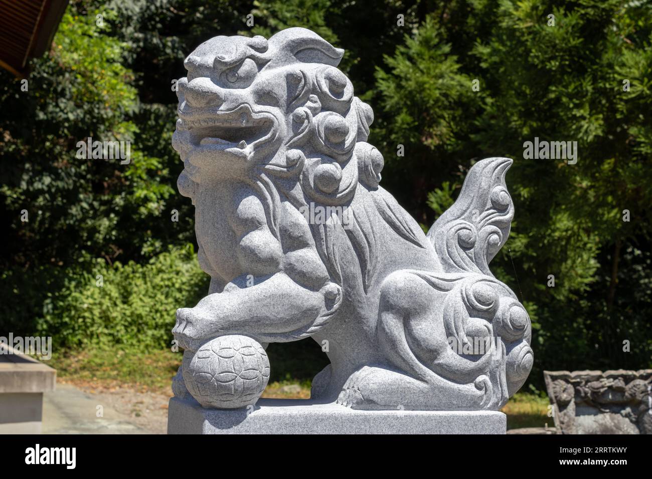Komainu, or lion-dog (public art) at Hachiman Shrine, Kaga, Japan. Komainu are the guardians of shinto shrines and sometimes temples, usually in pairs Stock Photo