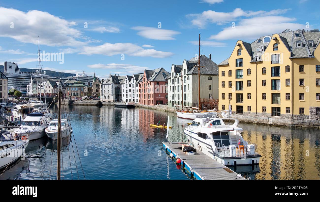 Picturesque view of the Brosundet Canal towards docked yachts and fishing boats, famous waterway crossing the old town with the beautiful architecture Stock Photo