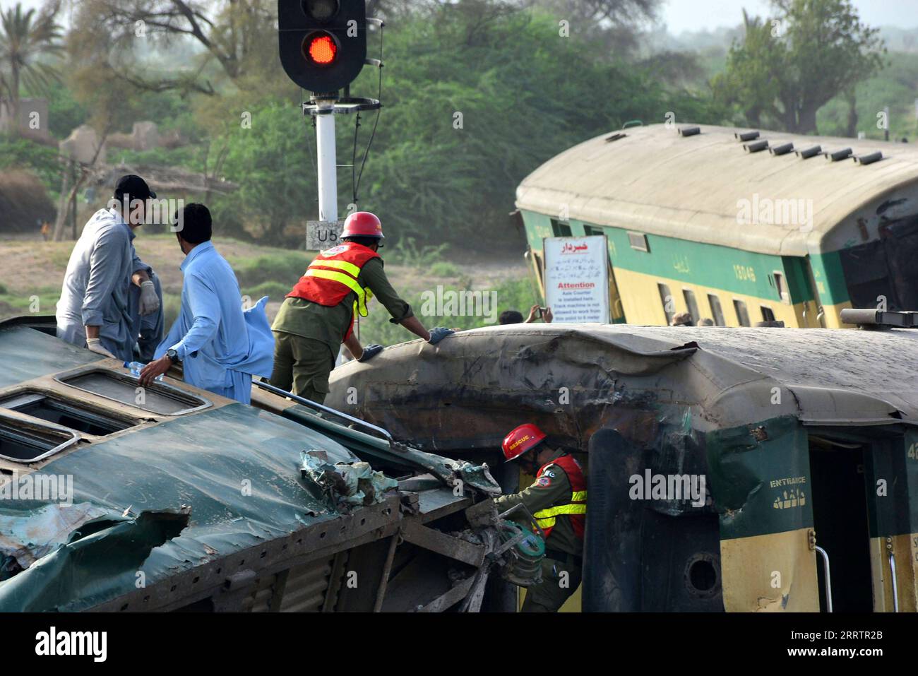 230807 -- SANGHAR, Aug. 7, 2023 -- Rescuers search for victims on derailed coaches of a passenger train in Sanghar district of Pakistan s southern Sindh province, on Aug. 6, 2023. At least 22 people were killed and over 50 others injured on Sunday after a passenger train derailed in the Sanghar district of Pakistan s southern Sindh province, local police said. The accident took place when 10 coaches of the Hazara Express train derailed when it was crossing a canal bridge near Sarhari town in the Shahdadpur area of the district, Muhammad Younis Chandio, deputy inspector general of police of the Stock Photo