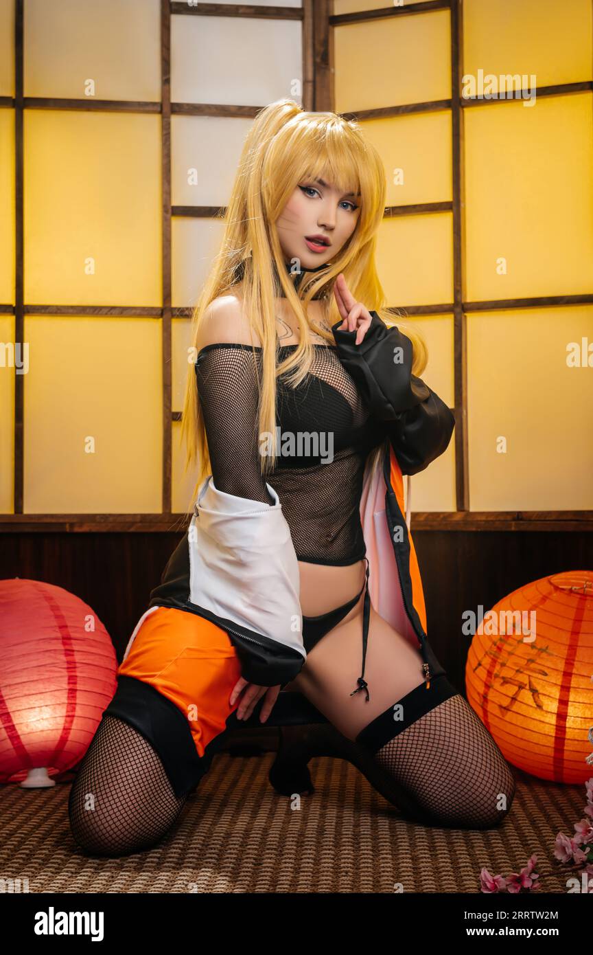 A cosplayer girl in the image of the character Naruko from the anime Naruto Stock Photo