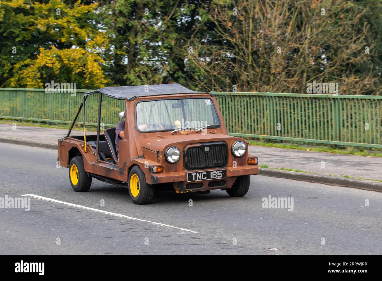 1960s Austin Mini Moke Style dilapidated brown open vehicle, a small, front-wheel-drive utility and recreational convertible. Front-engine, front-wheel drive, 850cc, four cylinders,45bhp British Classic. Stock Photo