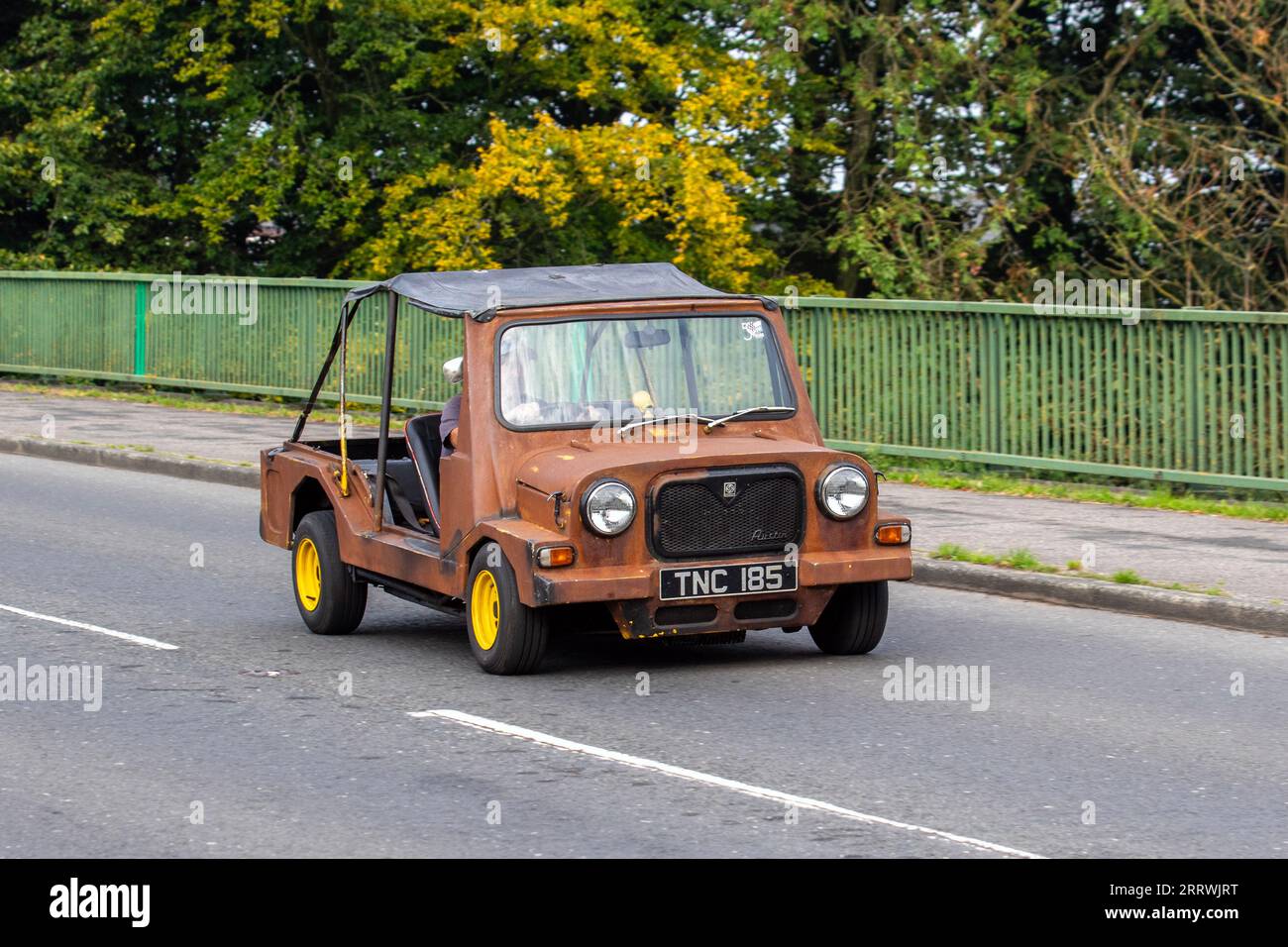 1960s Austin Mini Moke Style dilapidated brown open vehicle, a small, front-wheel-drive utility and recreational convertible. Front-engine, front-wheel drive, 850cc, four cylinders,45bhp British Classic. Stock Photo