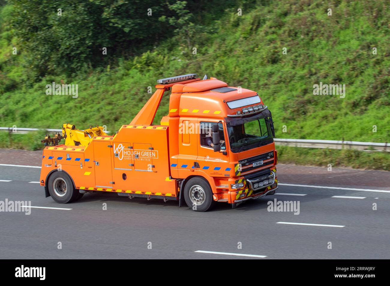 Hough Green Garage Ltd a HGV Recovery Services company 24hr nationwide accident HGV Breakdown vehicle recovery travelling on the M6 motorway UK. Orange Daf Trucks Ft Cf85.430 Diesel 2580 cc Stock Photo