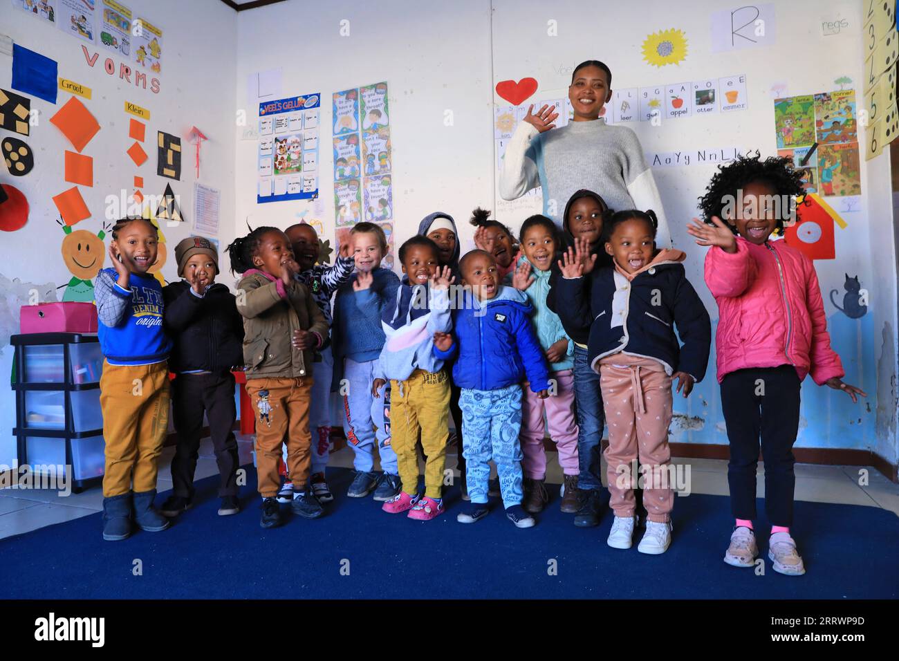 230817 -- CAPE TOWN, Aug. 17, 2023 -- A teacher and children pose for a group photo at an early learning center in De Aar Town, more than 750 kilometers northeast of Cape Town, South Africa, on Aug. 11, 2023. This early learning center was funded by Longyuan South Africa Renewables of China Longyuan Power Group Corporation Limited, which has funded the establishment of four early learning centers in De Aar to provide education for children from poor families. Nearly 500 children in need have been admitted to these learning centers so far.  SOUTH AFRICA-DE AAR-CHINA-EARLY LEARNING CENTER DongxJ Stock Photo