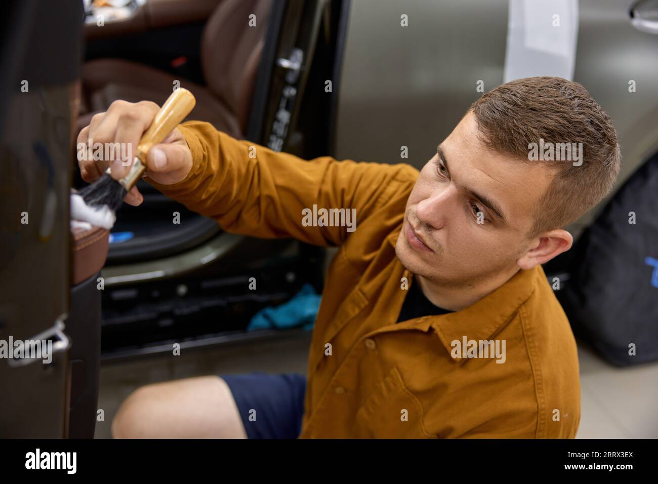 Car detailing, procedure, closeup master washing dashboard with soft