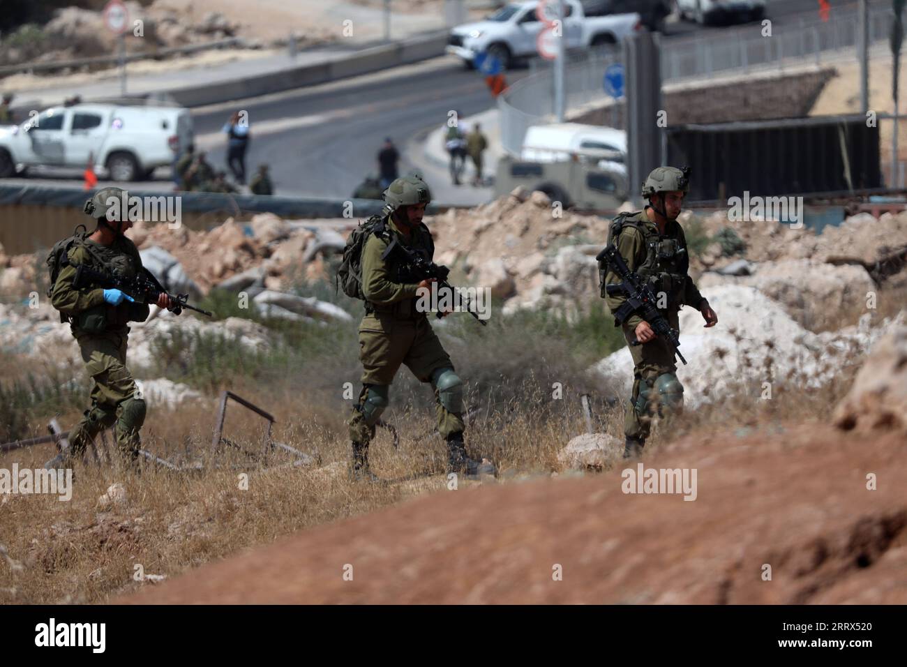 230821 -- HEBRON, Aug. 21, 2023 -- Members of Israeli forces are seen near the site of a reported attack outside the Jewish settlement of Beit Hagai, south of the West Bank city of Hebron, Aug. 21, 2023. An Israeli woman was killed, and a man was badly injured on Monday by a Palestinian gunman in a drive-by attack in the occupied West Bank, according to the Israeli military. Photo by /Xinhua MIDEAST-HEBRON-SHOOTING-ATTACK MamounxWazwaz PUBLICATIONxNOTxINxCHN Stock Photo