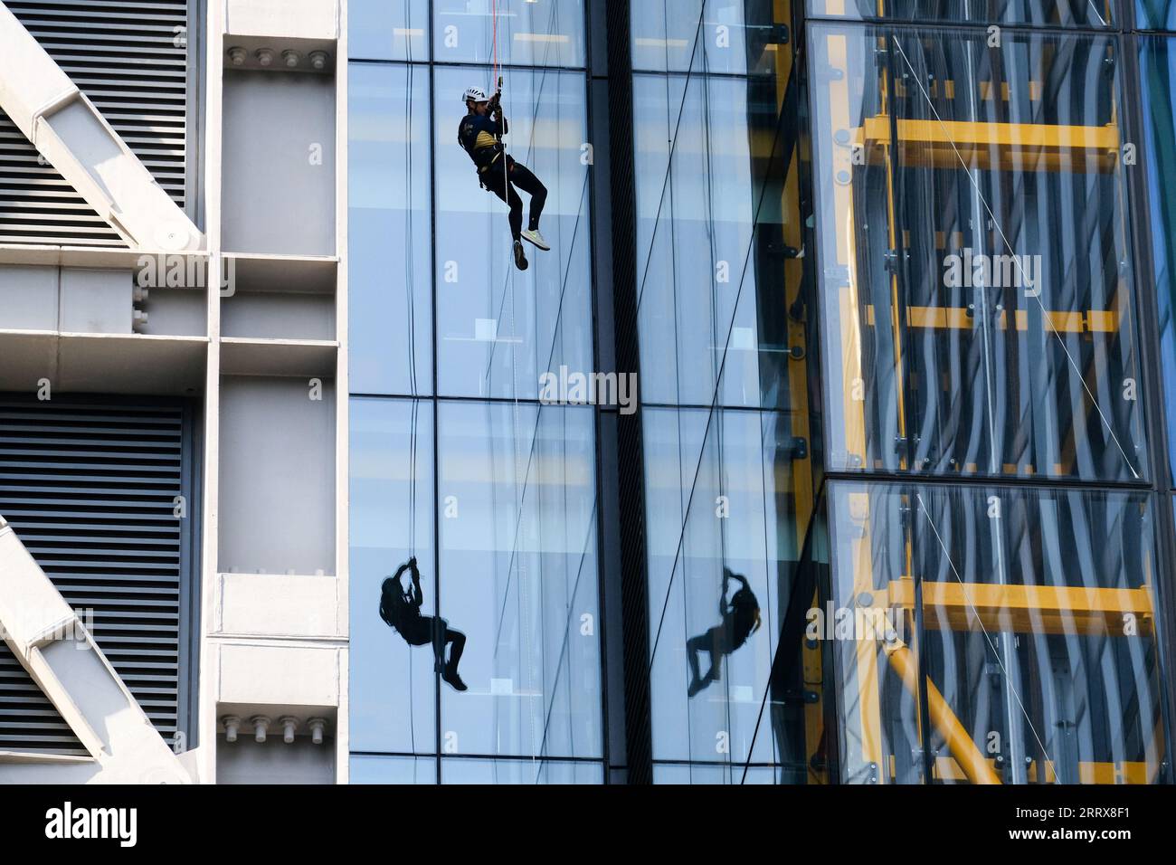 City of London, London, UK. 9th Sep 2023. The London Landmarks Skyscraper Challenge, with people running to the 42nd floor of The Cheesegrater then either abseiling down the Cheesegrater or zipwire to the Gherkin. An abseiler and reflections. Credit: Matthew Chattle/Alamy Live News Stock Photo