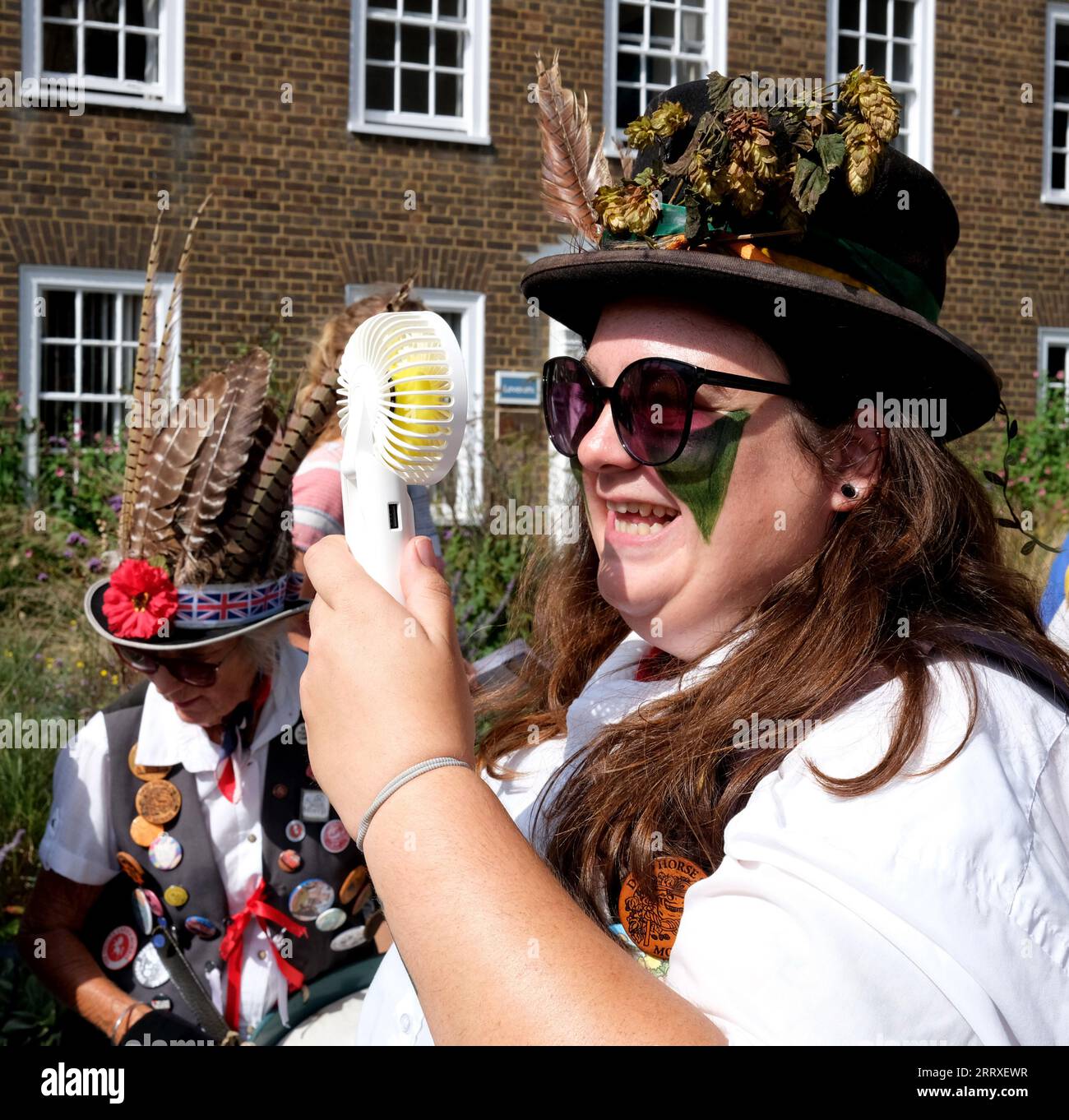 Canterbury, Kent, Uk. September 9th 2023. East Kent Morris dancers.  Following the annual Hop Hoodening service in Canterbury Cathedral Morris Dancers perform their traditional dances in sweltering heat with help from an electric fan to keep cool Credit: DAVE BAGNALL / Alamy Live News Stock Photo