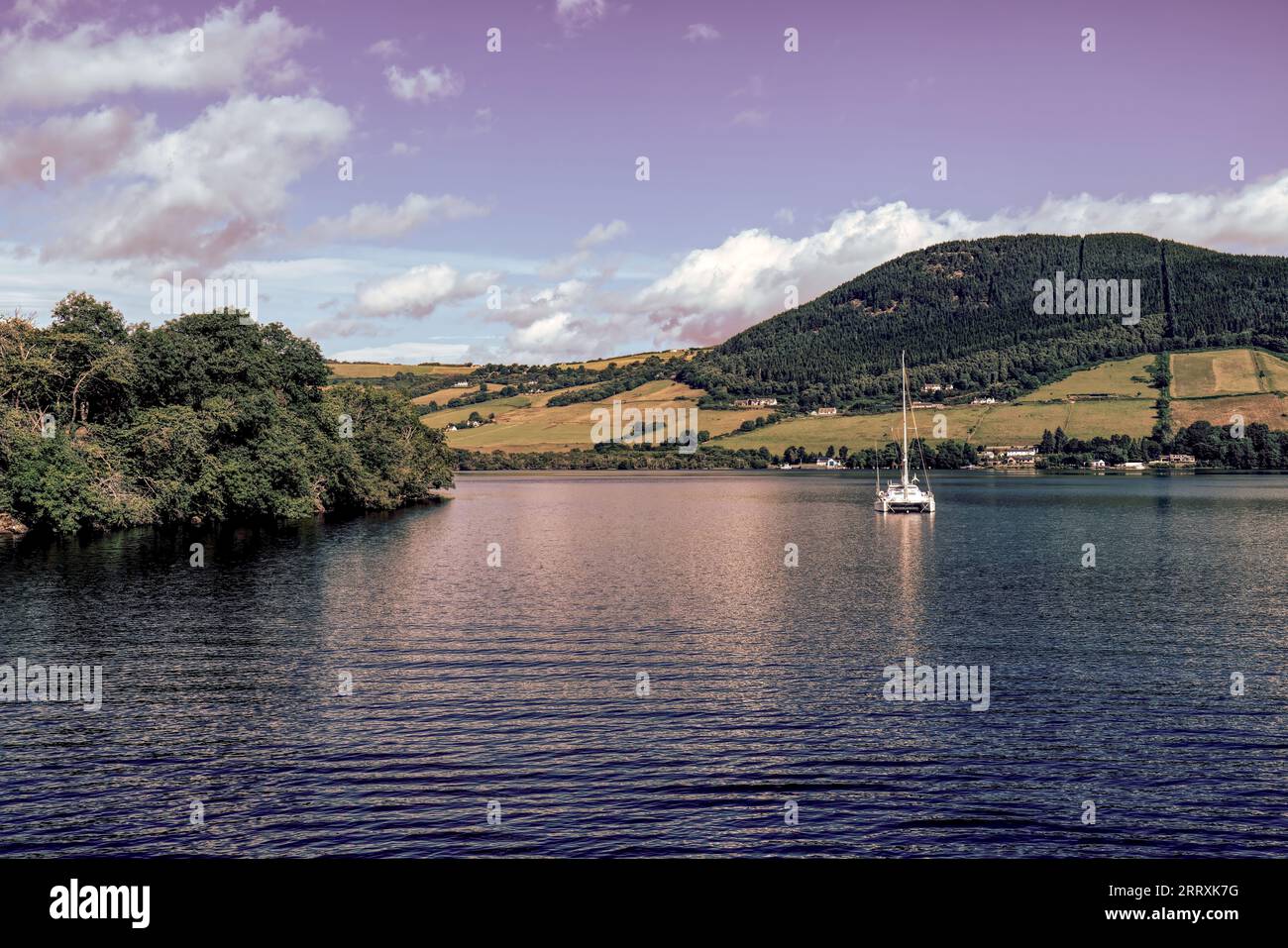 White Emissary: A Lone Boat on the Enigmatic Waters of Loch Ness Stock Photo