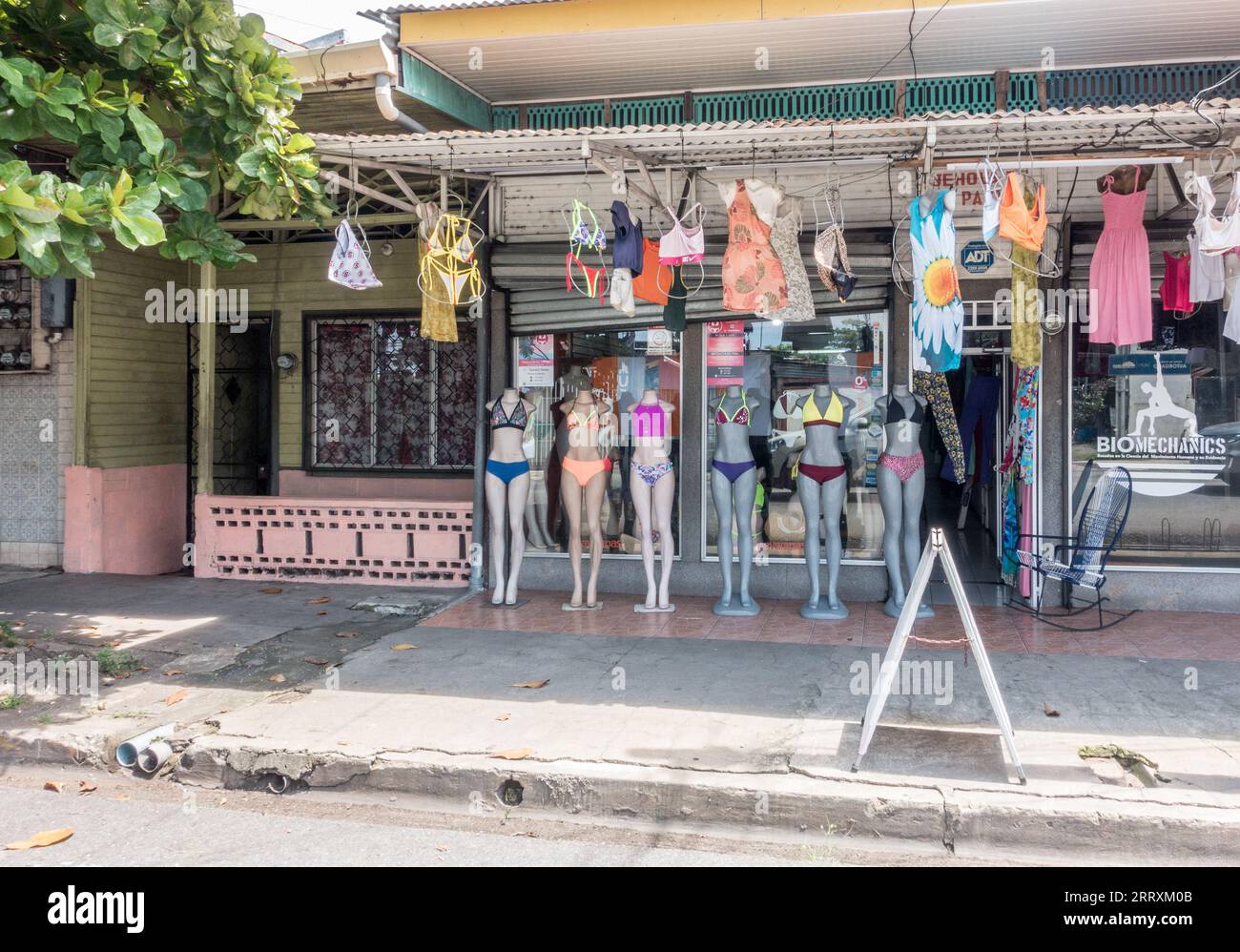 Mannequins displaying female swim suits in front of a clothing store in