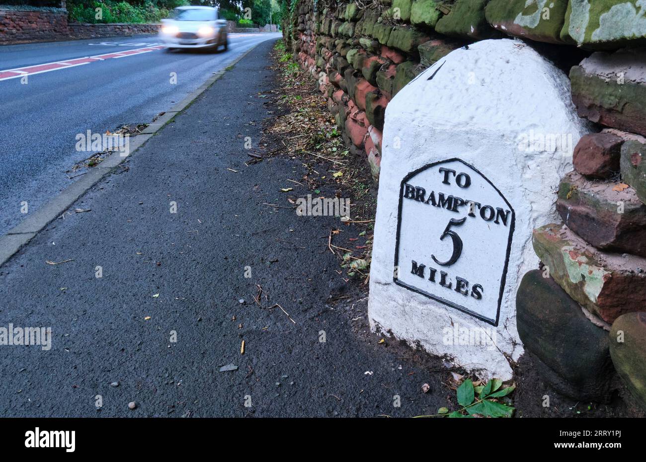 Traffic passing a milepost on the A69, near Aglionby, Carlisle, Cumbria Stock Photo