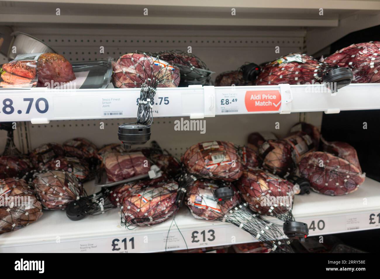 Security tags on meat at tesco, ashford, uk Stock Photo