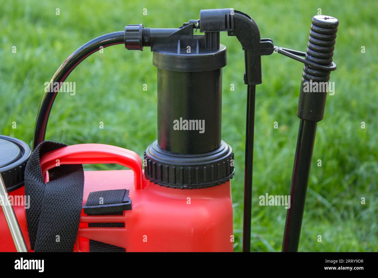 Red sprayer for agriculture on a green background Stock Photo