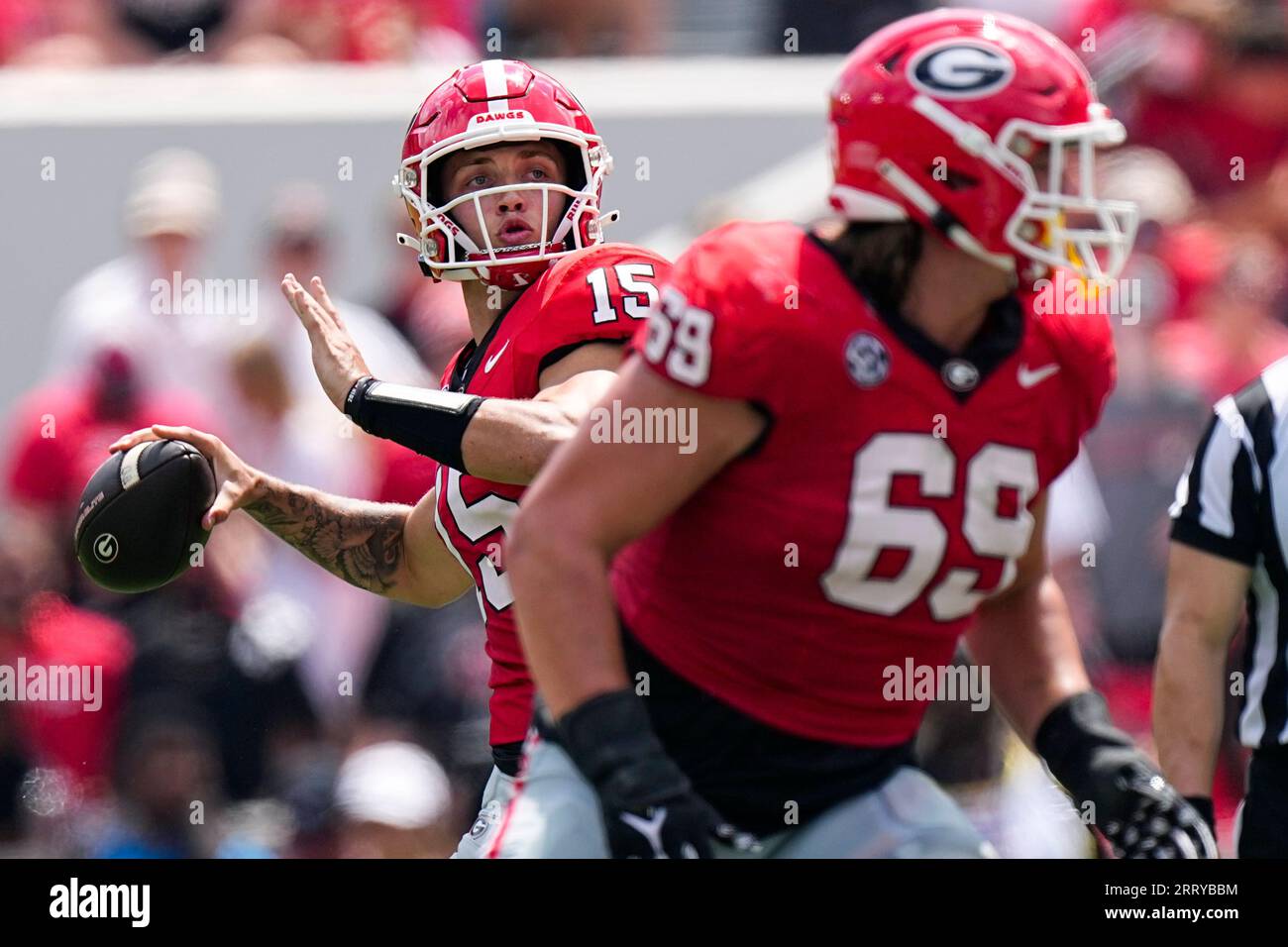 Georgia quarterback Carson Beck (15) throws a pass behind the blocking ...