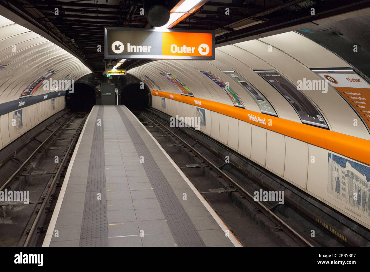 Shields road station on the Glasgow subway showing the narrow empty island platform with no passengers Stock Photo