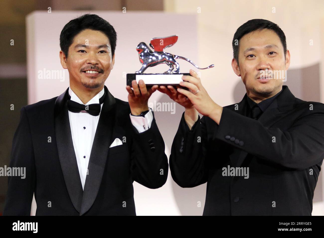 Italy, Lido di Venezia, September 9, 2023 : (r) Director Ryusuke Hamaguchi poses with (L) actor Hitoshi Omika, the Silver Lion Special Jury Prize for 'Aku Wa Sonzai Shinai' (Evil Does Not Exist) during the award winners red carpet at the 80th Venice International Film Festival on September 9, 2023 in Venice, Italy.    Photo © Ottavia Da Re/Sintesi/Alamy Live News Stock Photo