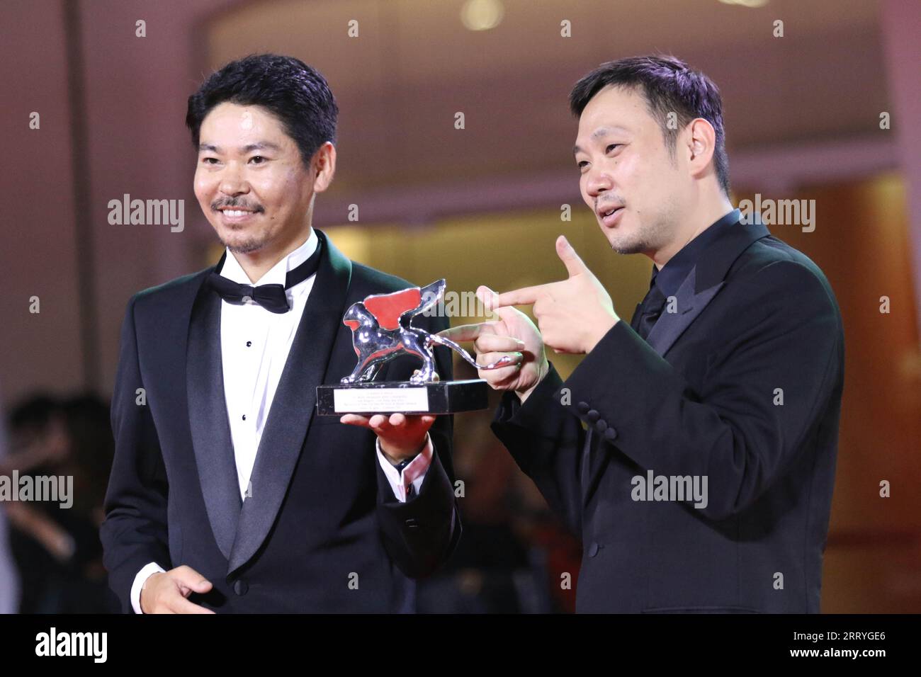 Italy, Lido di Venezia, September 9, 2023 : (r) Director Ryusuke Hamaguchi poses with (L) actor Hitoshi Omika, the Silver Lion Special Jury Prize for 'Aku Wa Sonzai Shinai' (Evil Does Not Exist) during the award winners red carpet at the 80th Venice International Film Festival on September 9, 2023 in Venice, Italy.    Photo © Ottavia Da Re/Sintesi/Alamy Live News Stock Photo