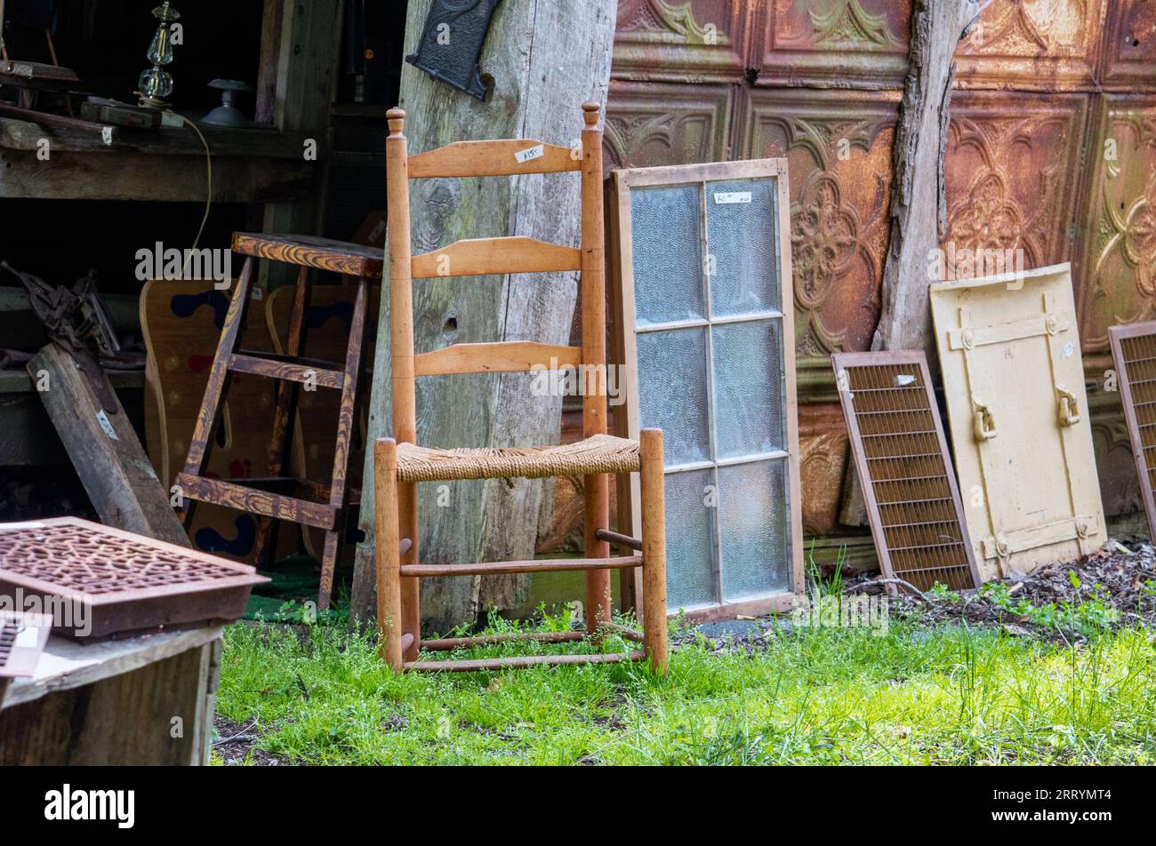 Barn sale outdoors has a variety of odd furniture, windows, doors and
