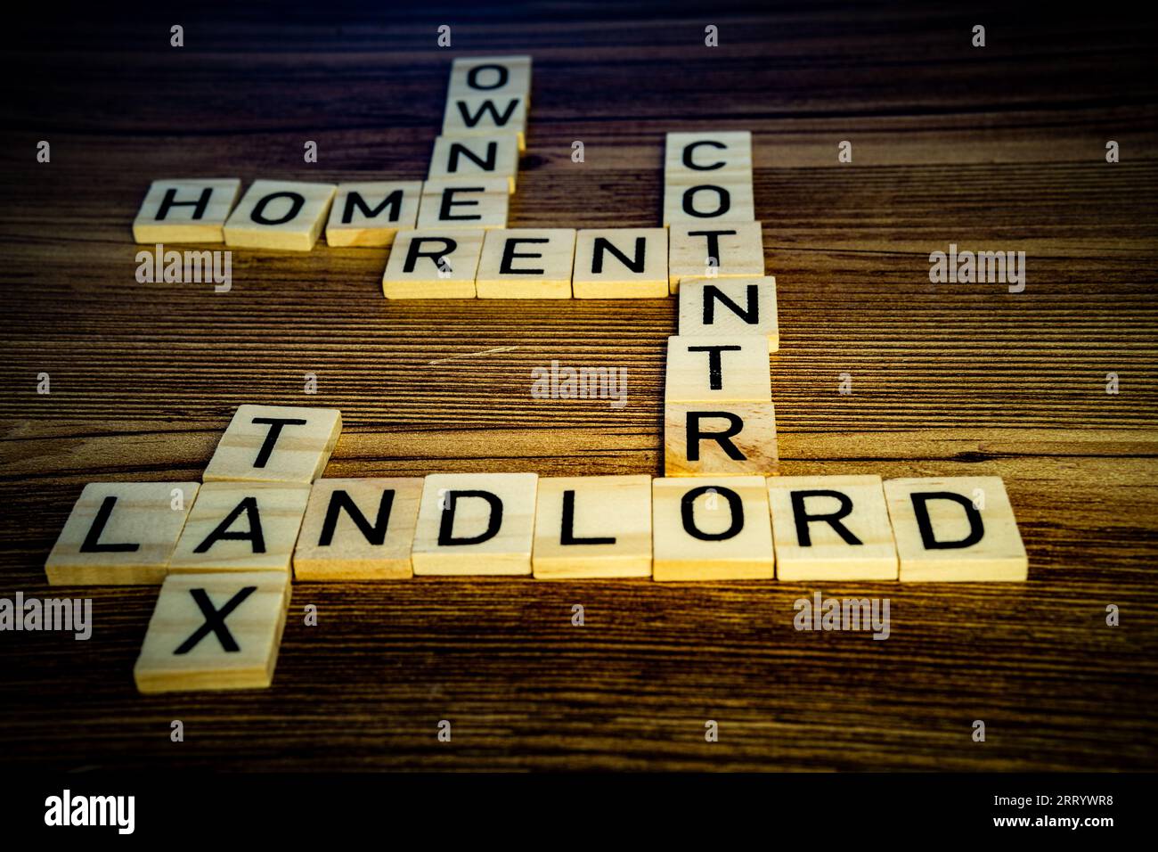 home rent control landlord housing crisis crossword puzzle in wooden letters on a wood background Stock Photo