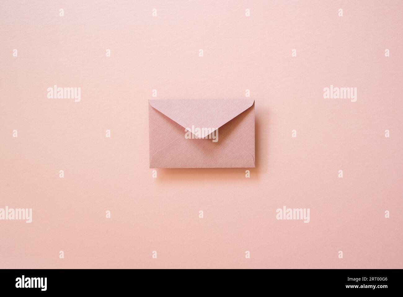 Envelope isolated on pink background. top view, copy space Stock Photo