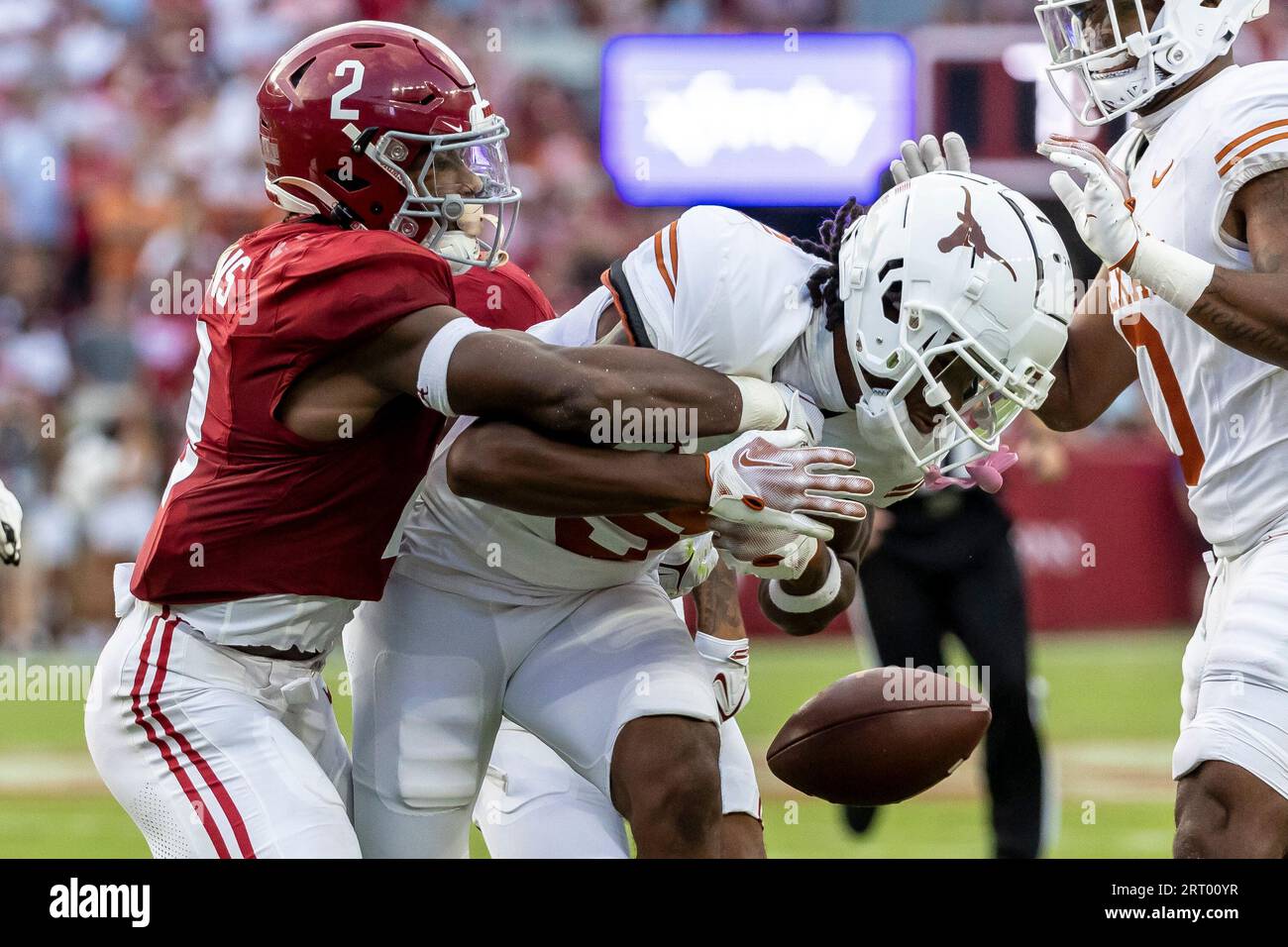 Alabama defensive back Caleb Downs (2) forces a fumble from Texas wide  receiver Isaiah Neyor (9) during the first half of an NCAA college football  game, Saturday, Sept. 9, 2023, in Tuscaloosa,
