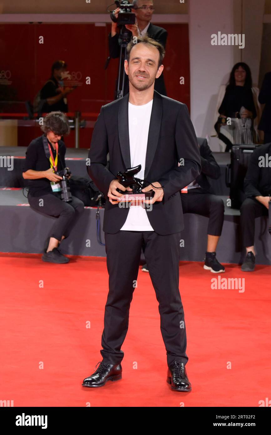 Venice Lido, Italy. 09th Sep, 2023. Erenik Beqiri poses with the Best Short Film Award for film 'A Short Trip' at the winner's photocall at the 80th Venice International Film Festival Credit: SOPA Images Limited/Alamy Live News Stock Photo