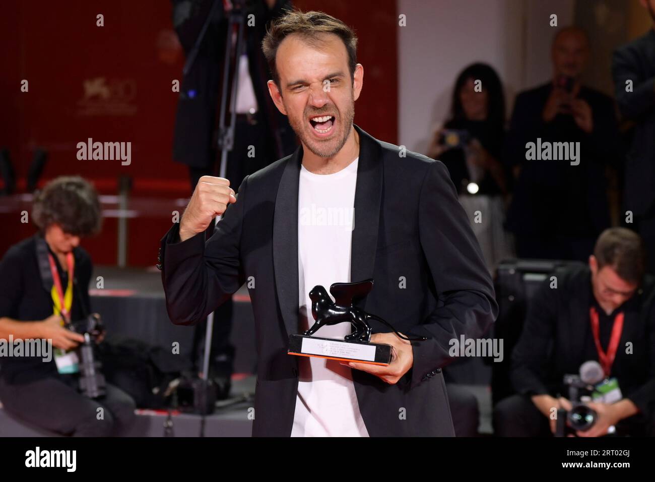 Venice Lido, Italy. 09th Sep, 2023. Erenik Beqiri poses with the Best Short Film Award for film 'A Short Trip' at the winner's photocall at the 80th Venice International Film Festival Credit: SOPA Images Limited/Alamy Live News Stock Photo