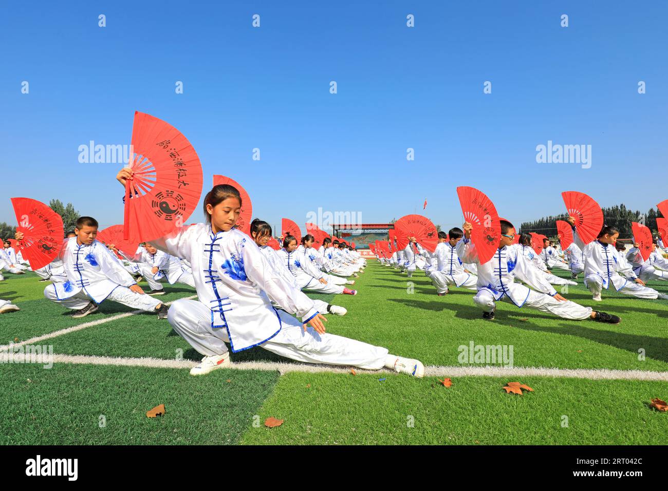 LUANNAN COUNTY, Hebei Province, China - September 30, 2020: Middle school students practice Taiji Fan on the playground Stock Photo