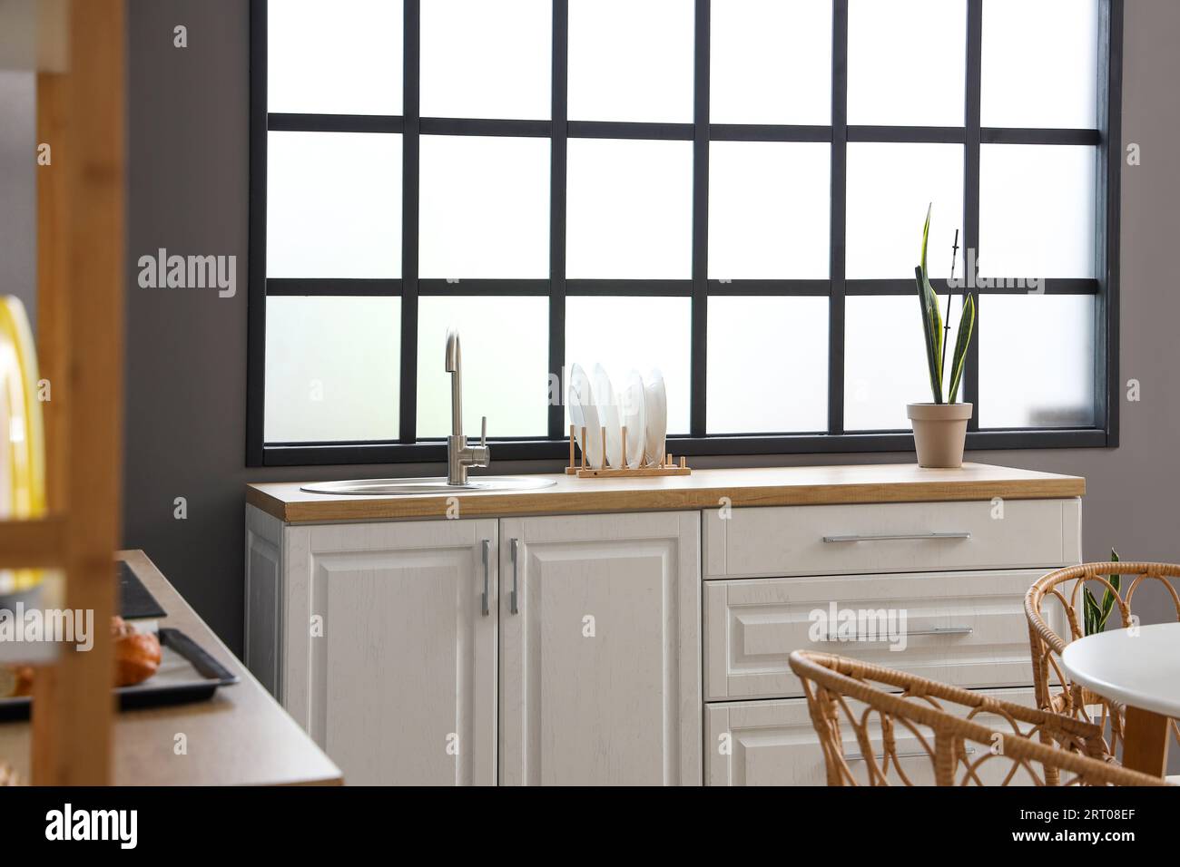 Interior of modern kitchen with white counters and sink Stock Photo - Alamy