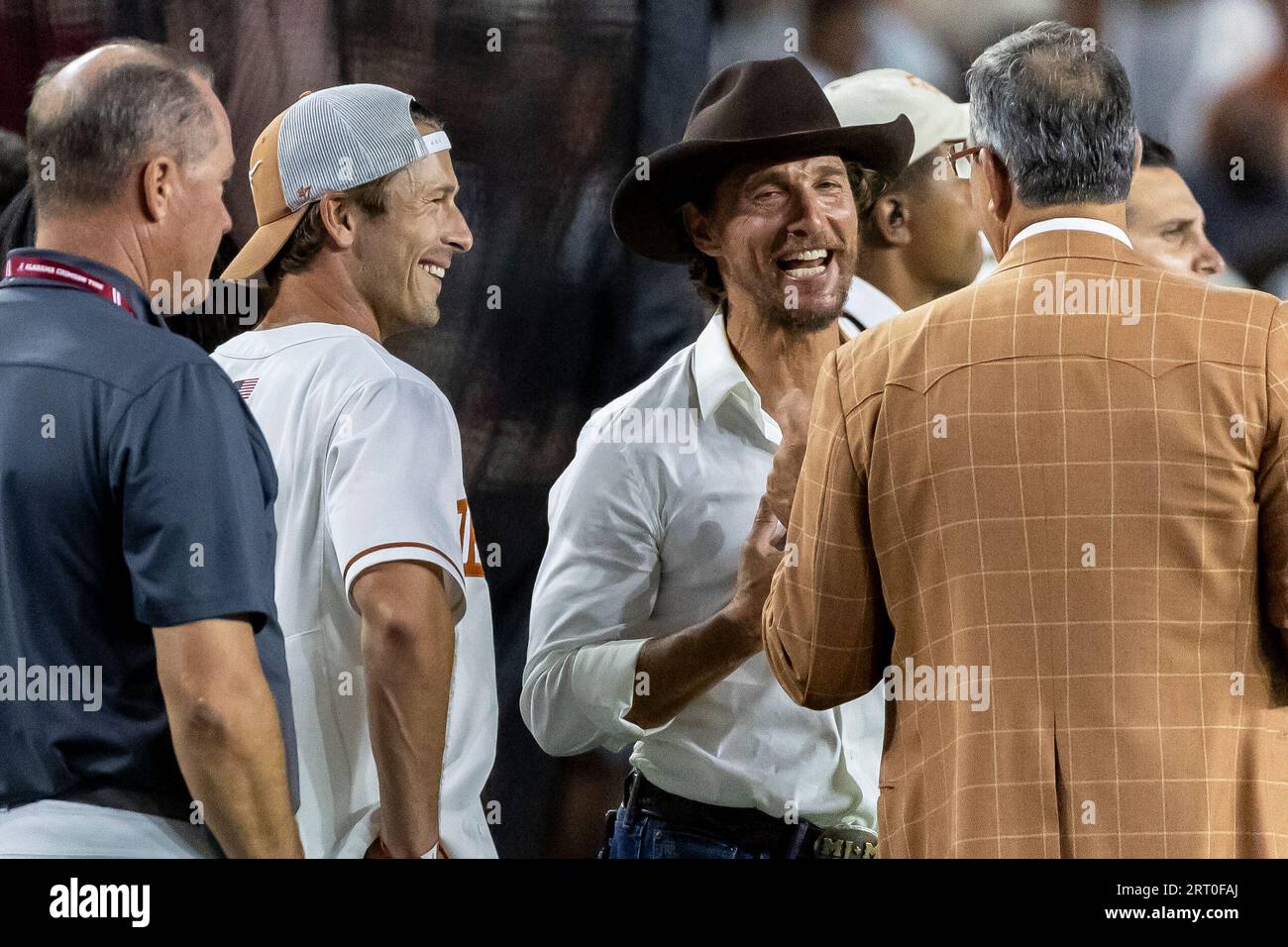 Actors Glen Powell, Texas baseball cap, and Matthew McConaughey, brown