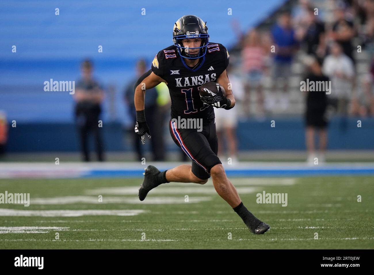 Kansas wide receiver Luke Grimm runs the ball during the first half of