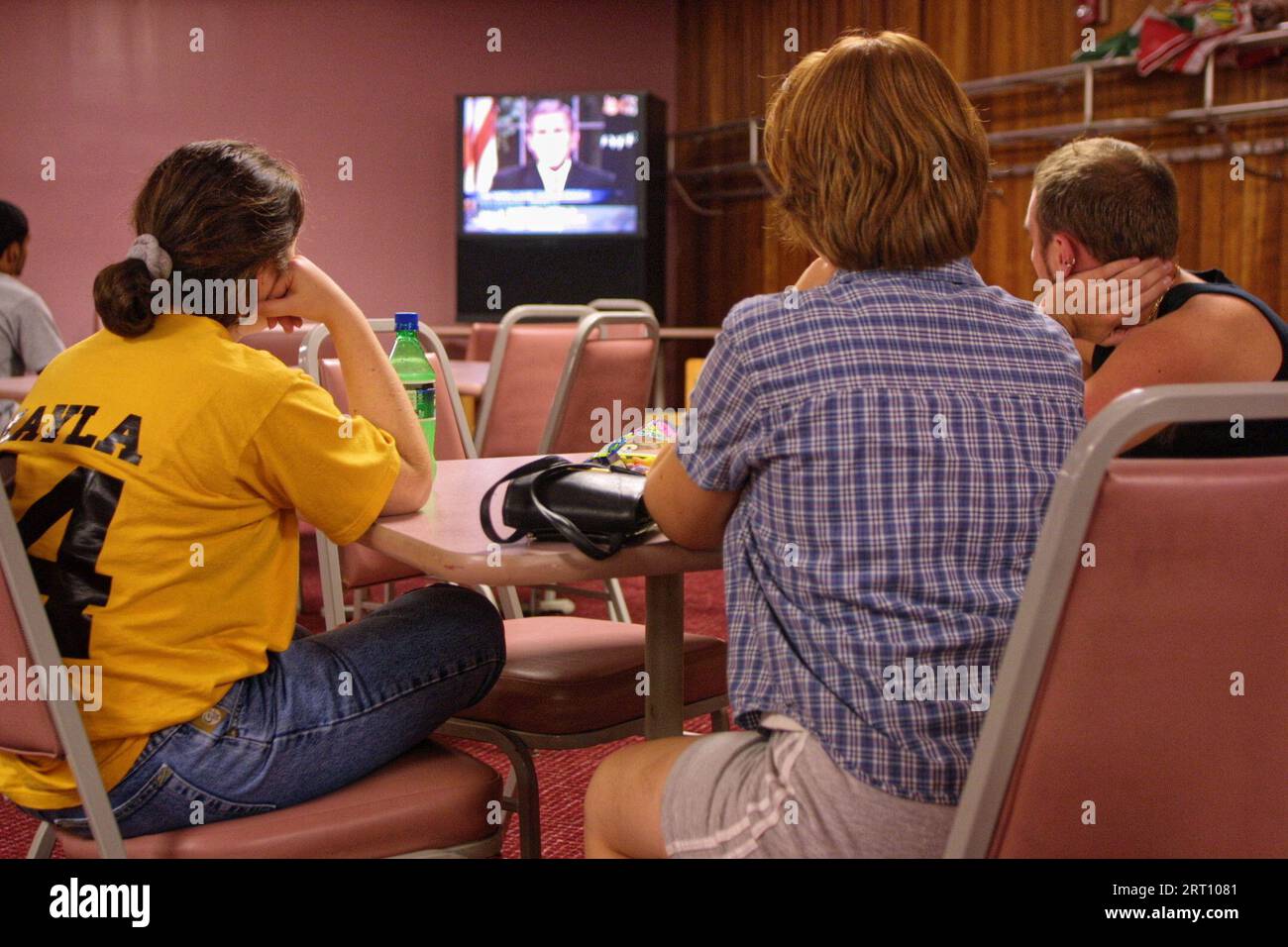Eastern Kentucky University students (from left) Kayla Stephens of Greenup, Adrienne Keagle of Newport and Paul Shamhart of Lexington watch television as President George W. Bush speaks live from the Oval Office regarding terrorist attacks taking place earlier in the day on Tuesday, Sept. 11, 2001 in Richmond, Madison County, KY, USA. 'Today, our fellow citizens, our way of life, our very freedom, came under attack in a series of deliberate and deadly terrorist acts,' Bush said of the Sept. 11 terrorist attacks in his televised address to the nation. (Apex MediaWire Photo by Billy Suratt) Stock Photo