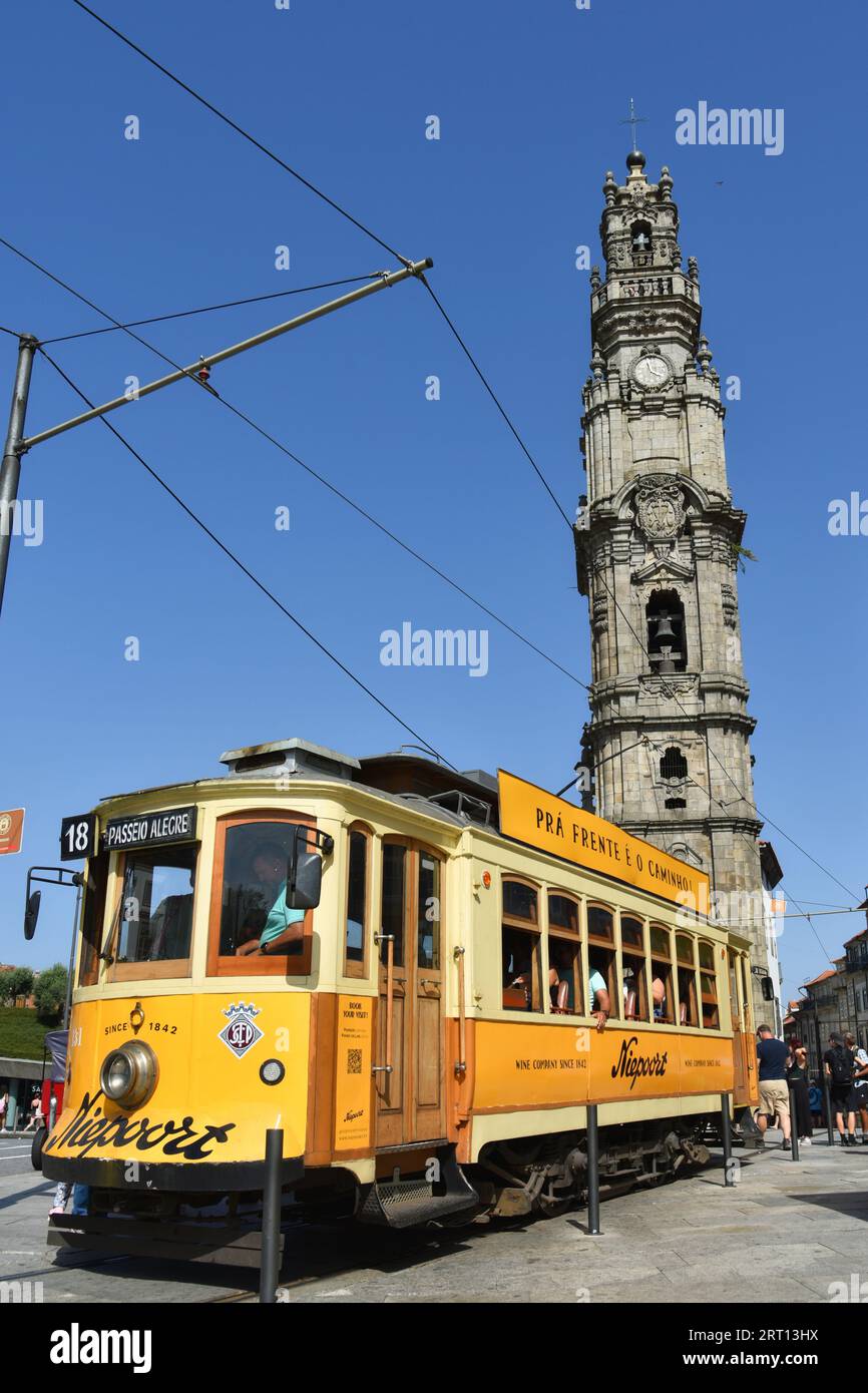 PORTO, PORTUGAL - AUGUST 24, 2023: Old tram near the Clerigos Tower, torre dos clerigos, famous landmark and symbol of the Oporto. Stock Photo