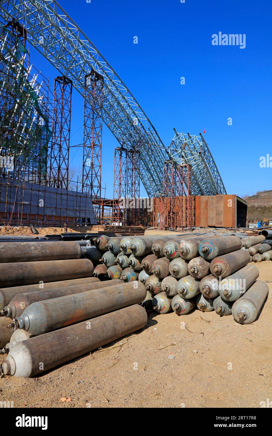 Steel frame and compressed gas cylinders in a construction site Stock Photo